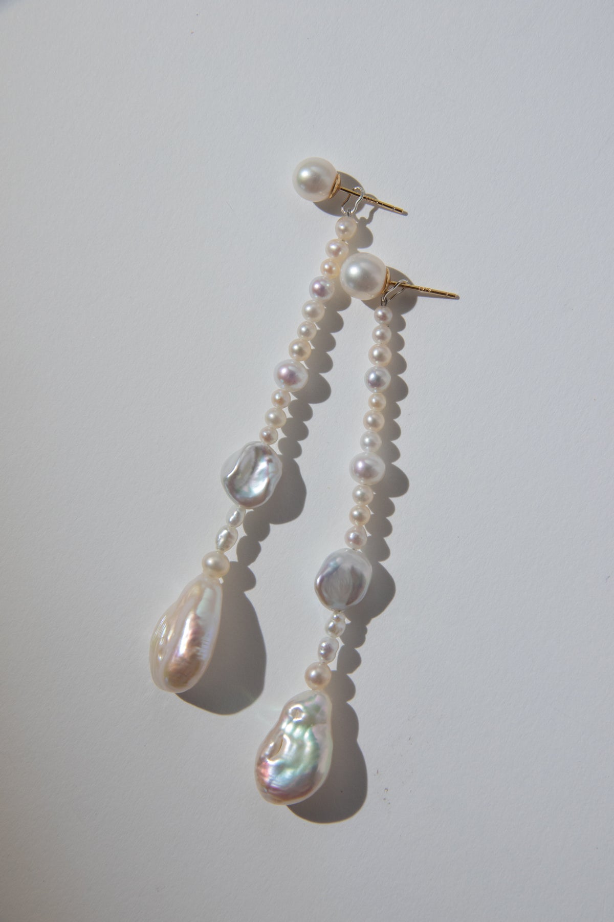 Long Irregular white pearls Jacket structure earring.