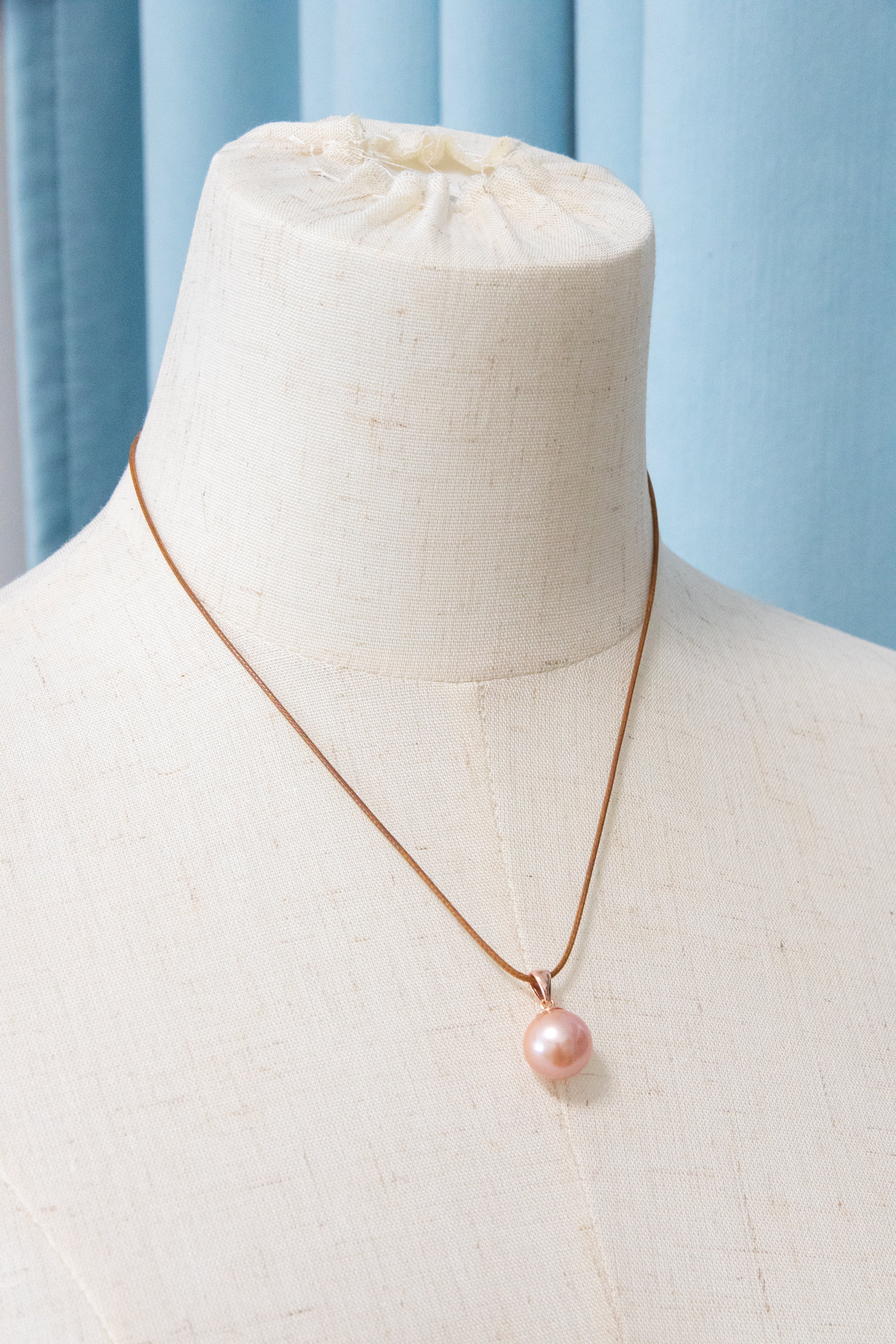 Excellent collection levle perfect round natural pink pearl-rose gold bail.