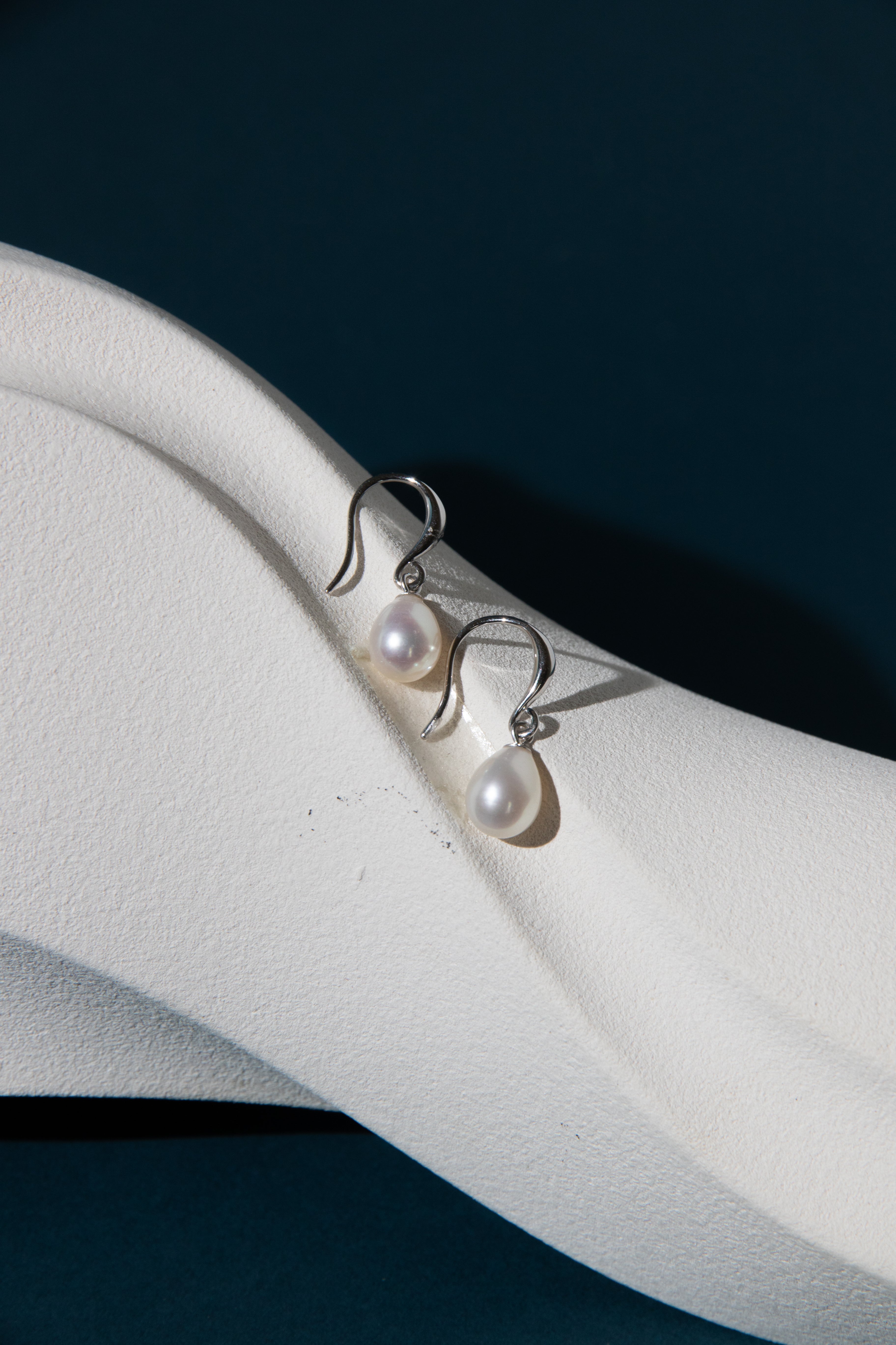 silver earring with a pair of white freshwater drop pearl.