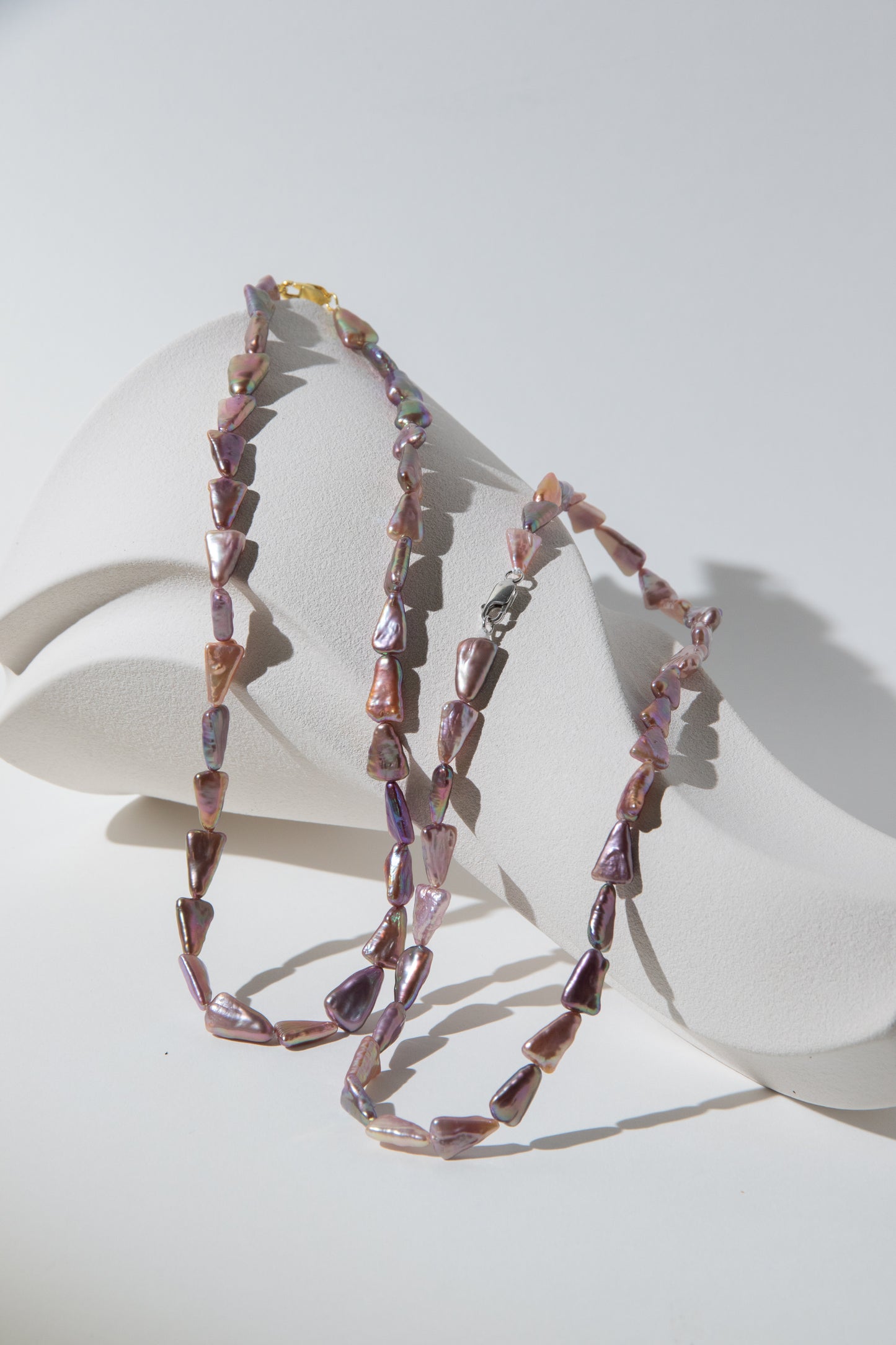 Direction pearl necklace-natural purple colored triangle pearls in silver/ gold plated silverclasps.
