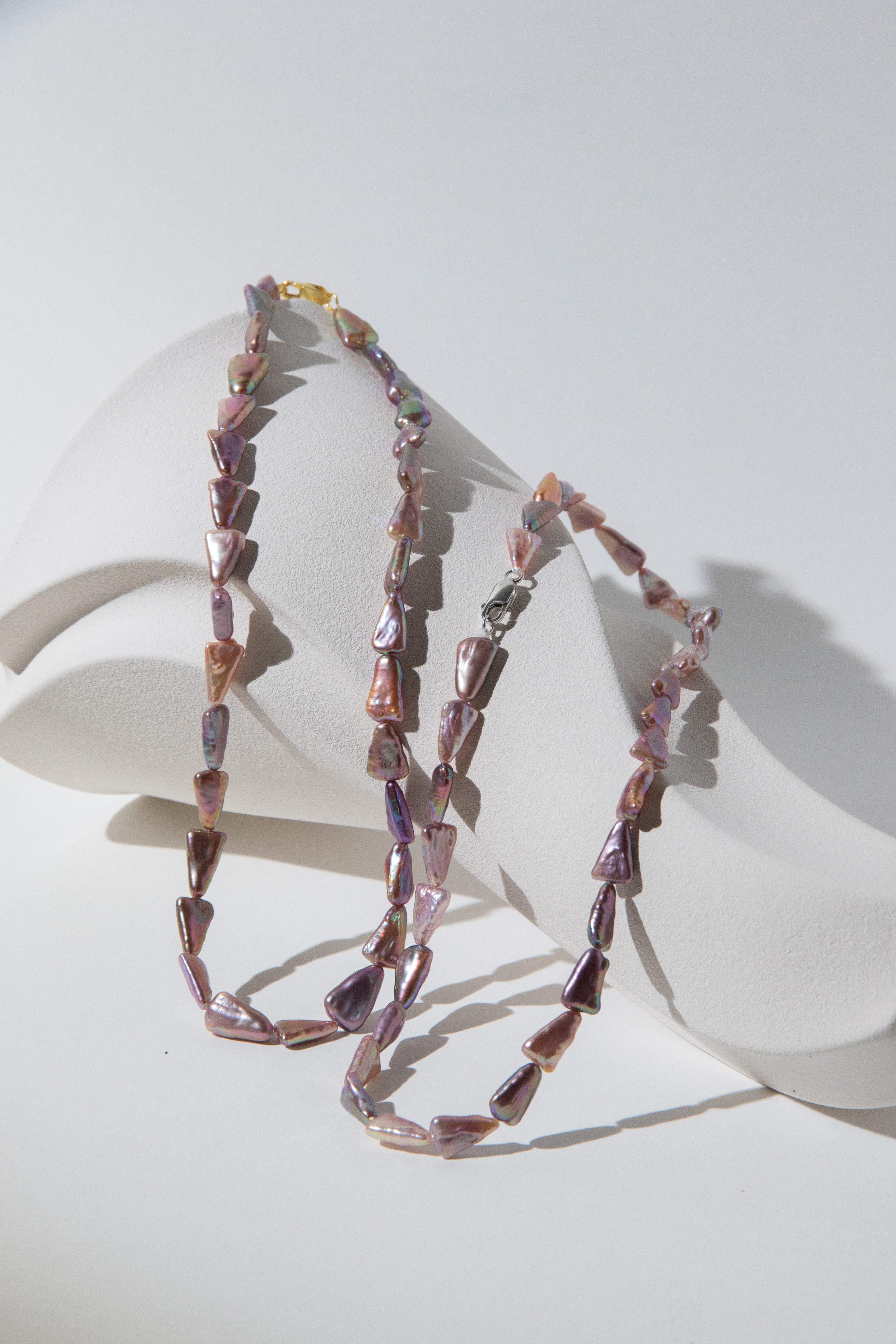 Direction pearl necklace-natural purple colored triangle pearls in silver/ gold plated silverclasps.