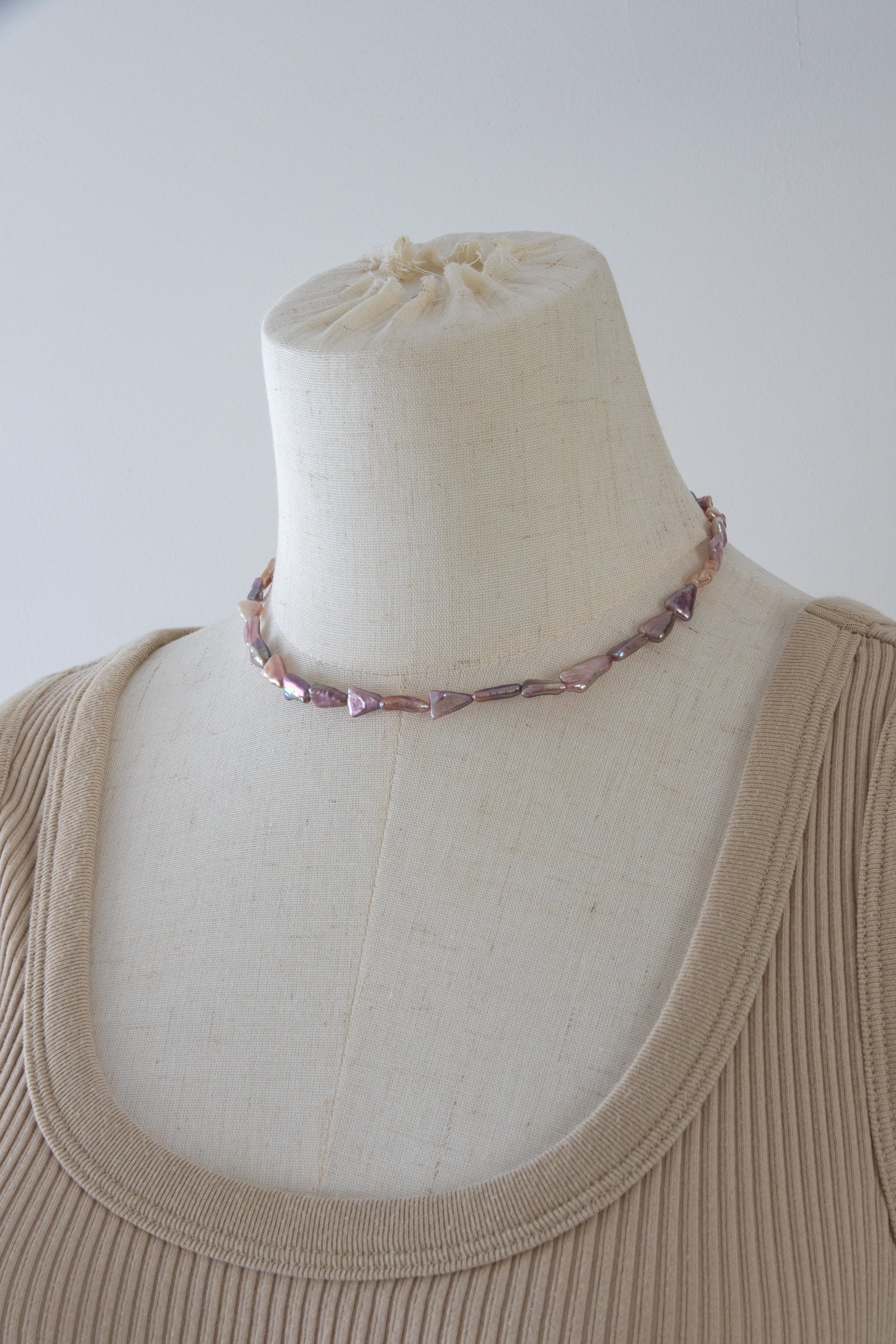 Direction pearl necklace-natural purple colored triangle pearls in silver/ gold plated silverclasps.