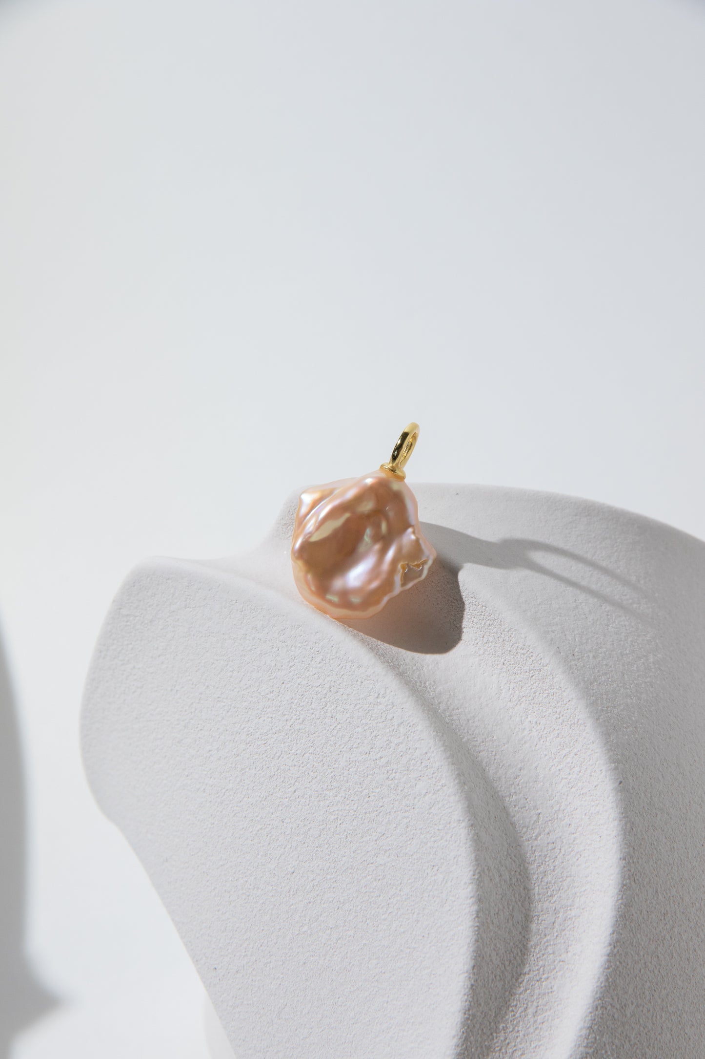 Watery sunset lake-natural orange pink colored thick seedless petal pearl pendant.