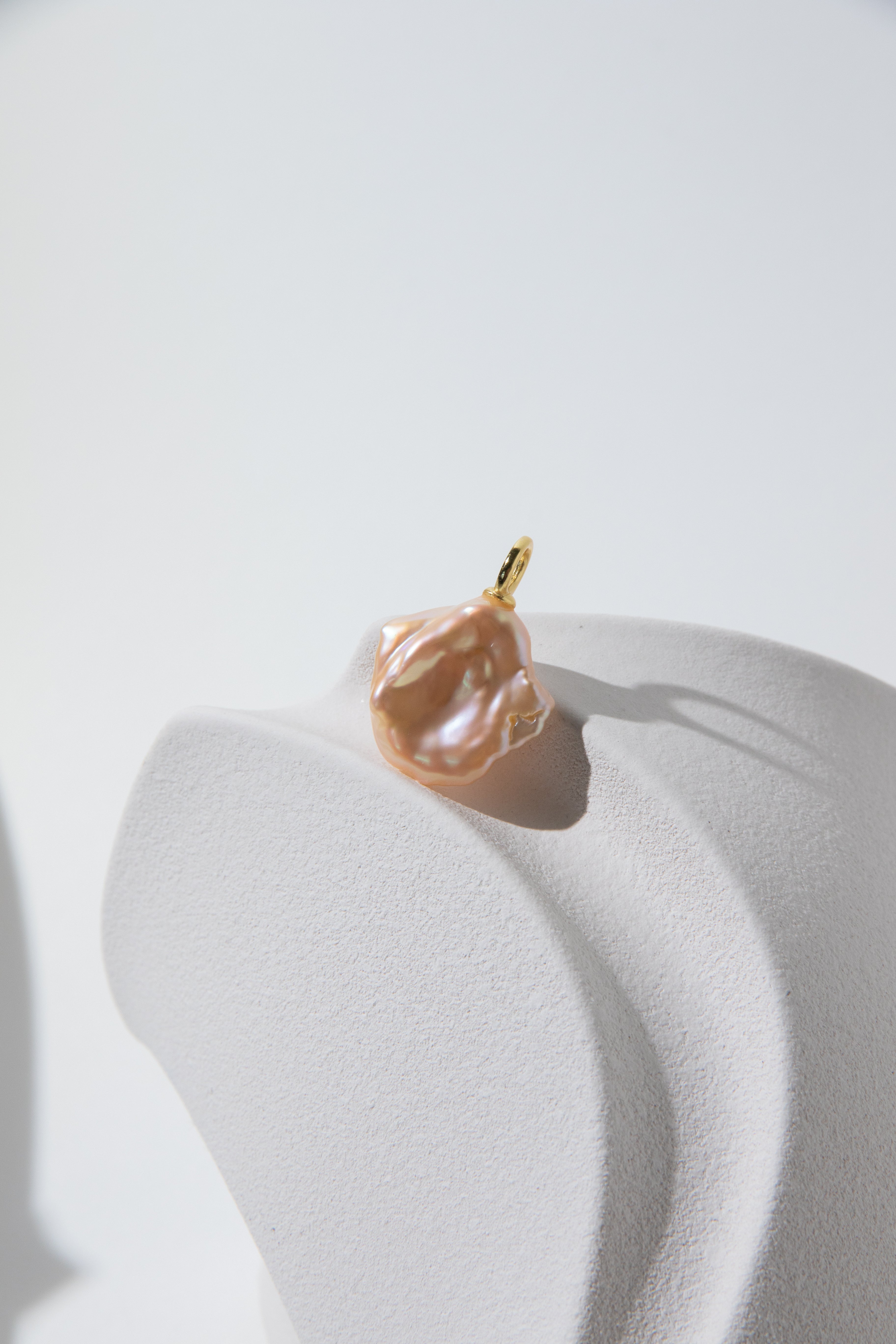 Watery sunset lake-natural orange pink colored thick seedless petal pearl pendant.
