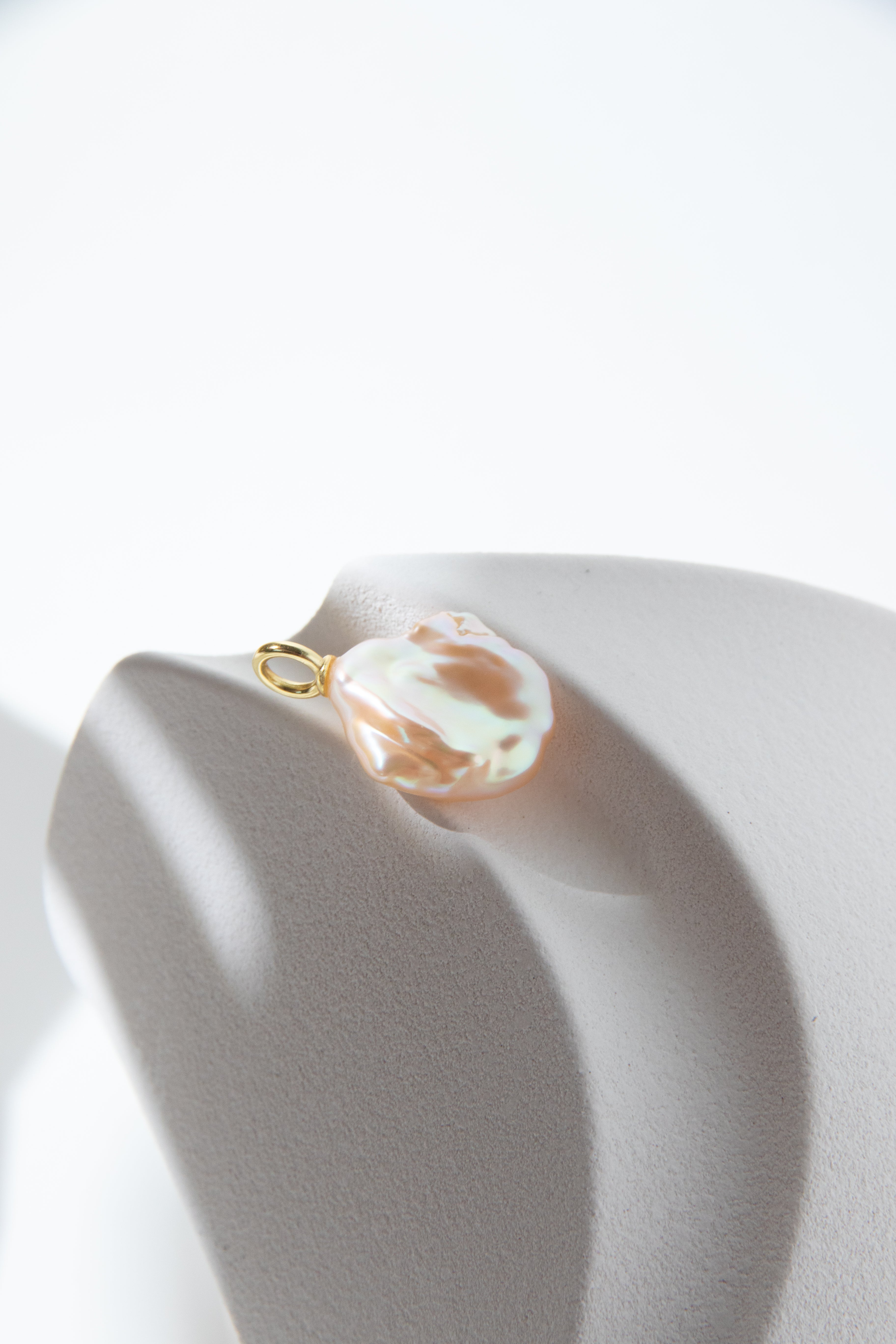 Watery sunset lake-natural orange pink colored thick seedless petal pearl pendant.
