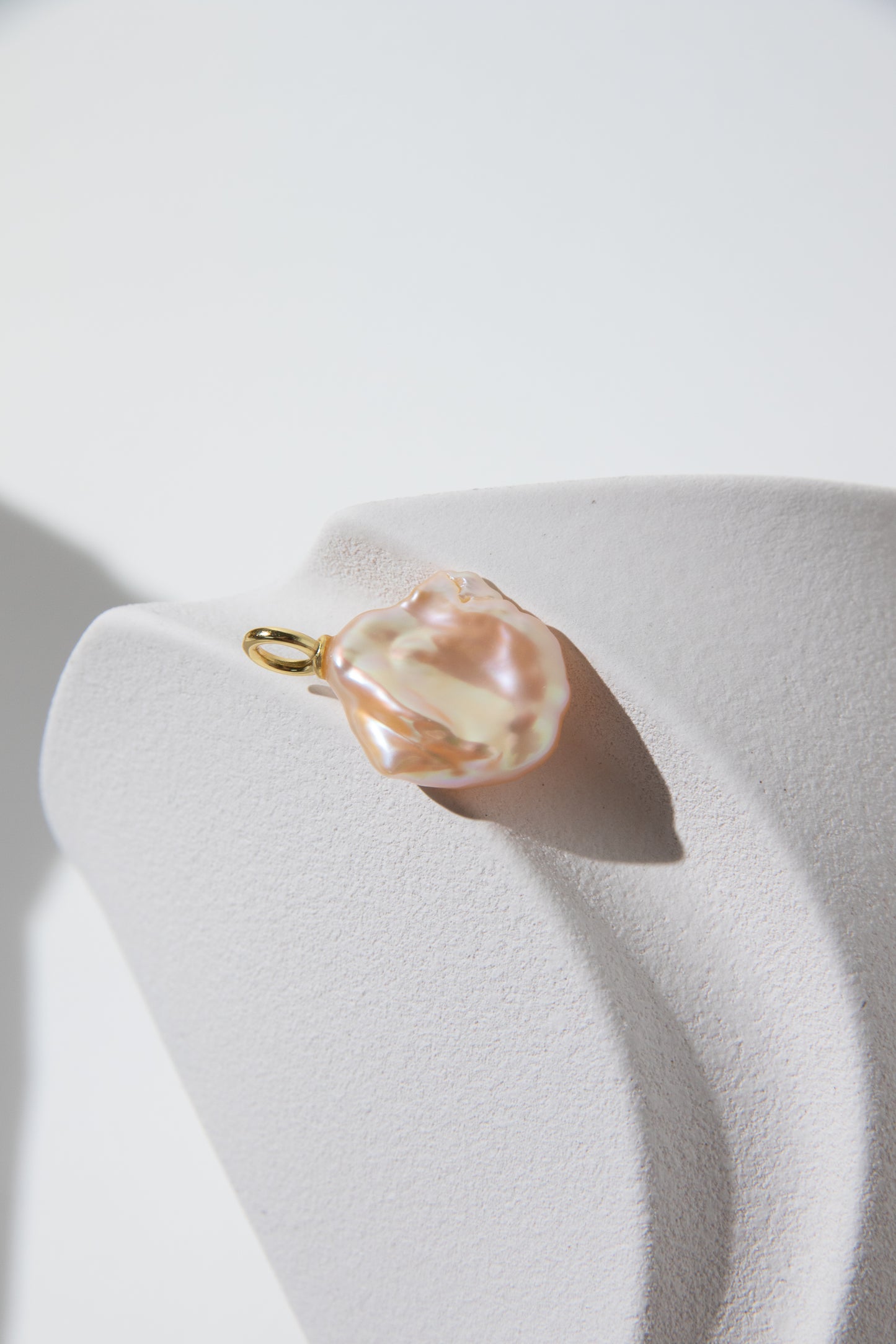 Watery sunset lake-natural orange pink colored thick seedless petal pearl pendant.