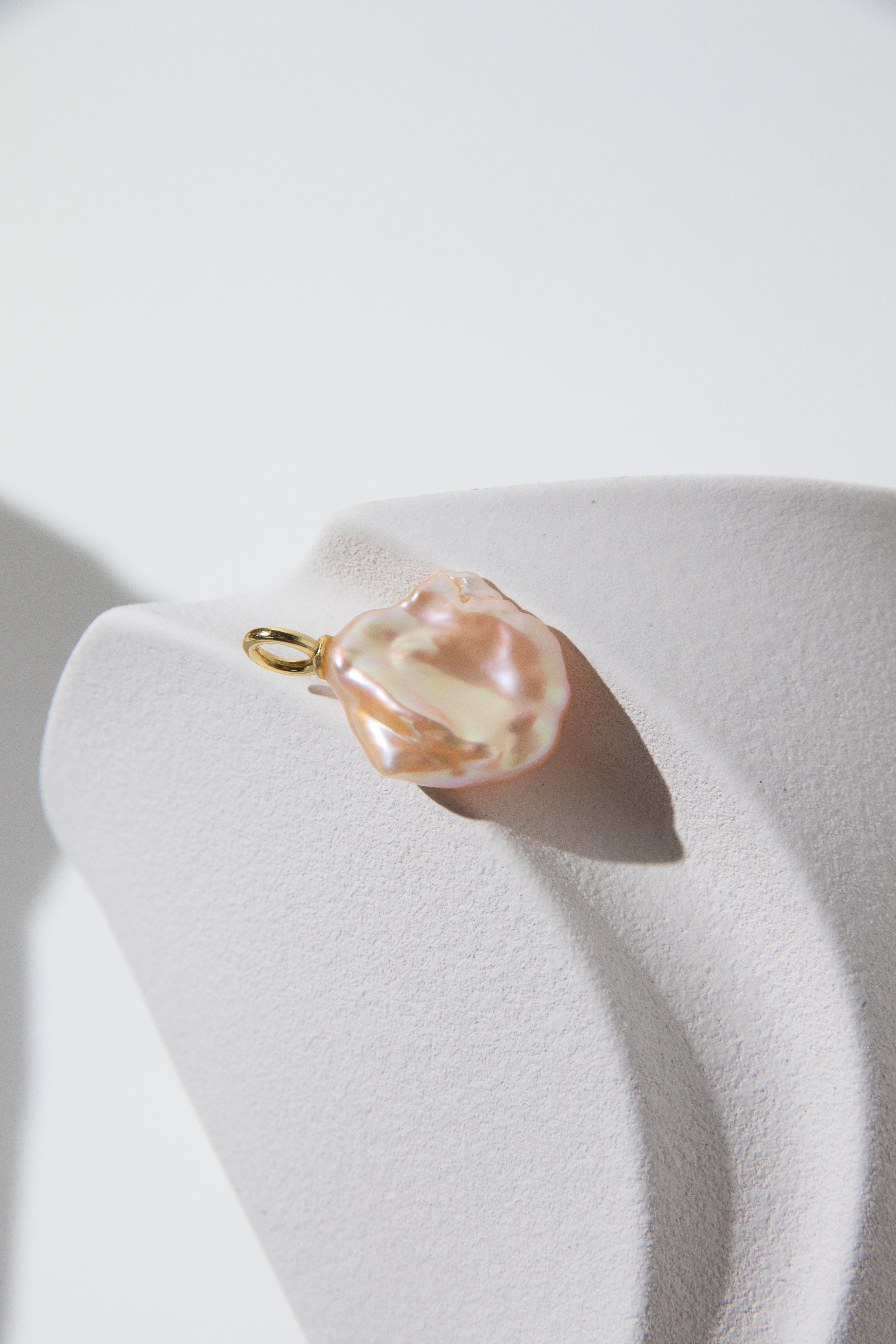 Watery sunset lake-natural orange pink colored thick seedless petal pearl pendant.