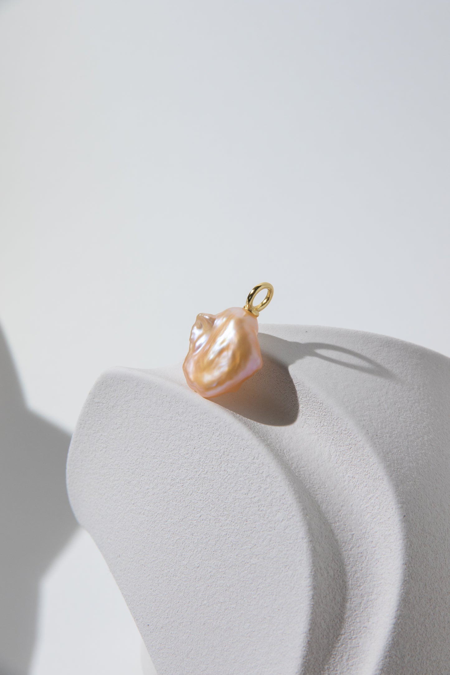 Watery sunset lake-natural orange pink colored thick seedless petal pearl pendant.