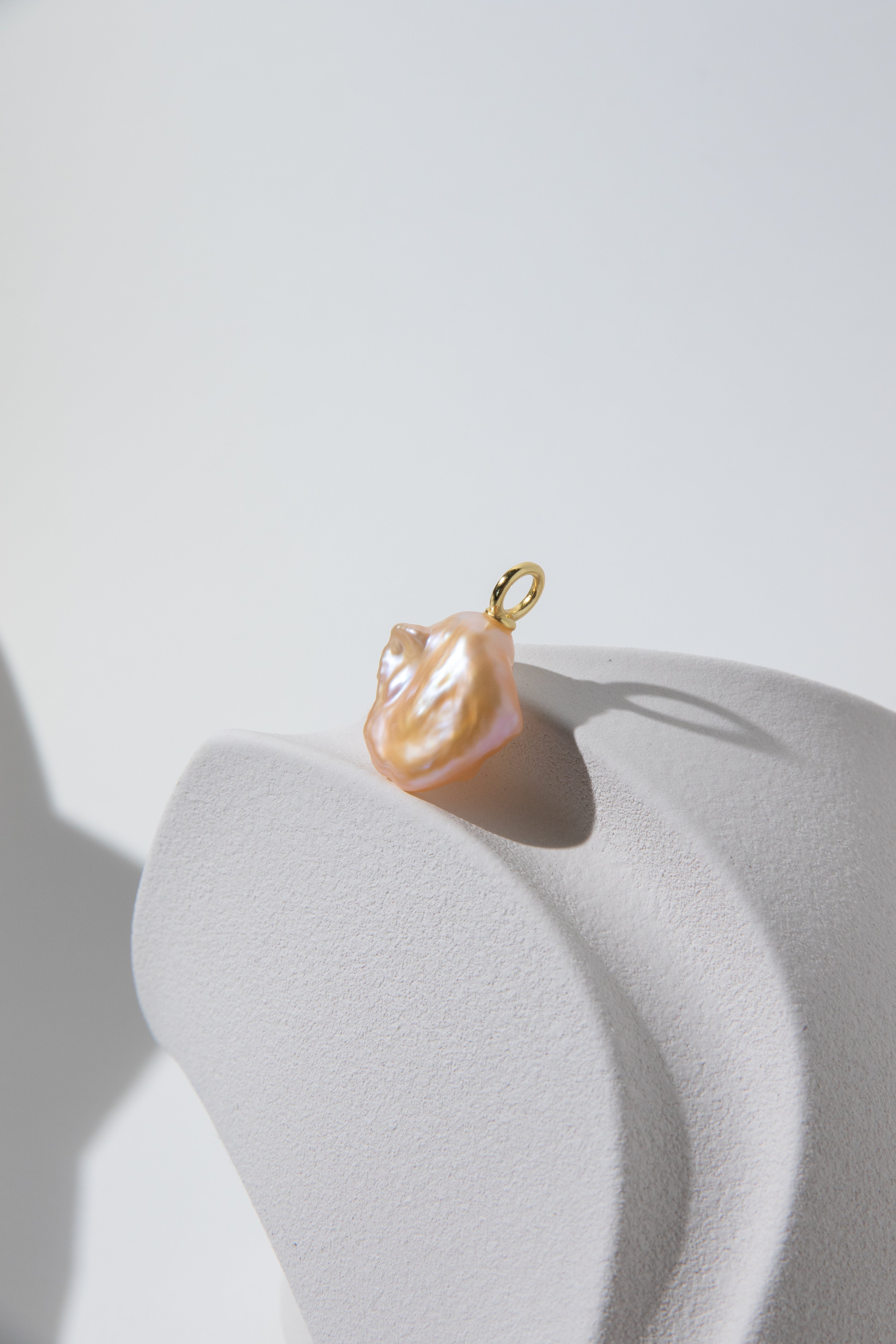 Watery sunset lake-natural orange pink colored thick seedless petal pearl pendant.