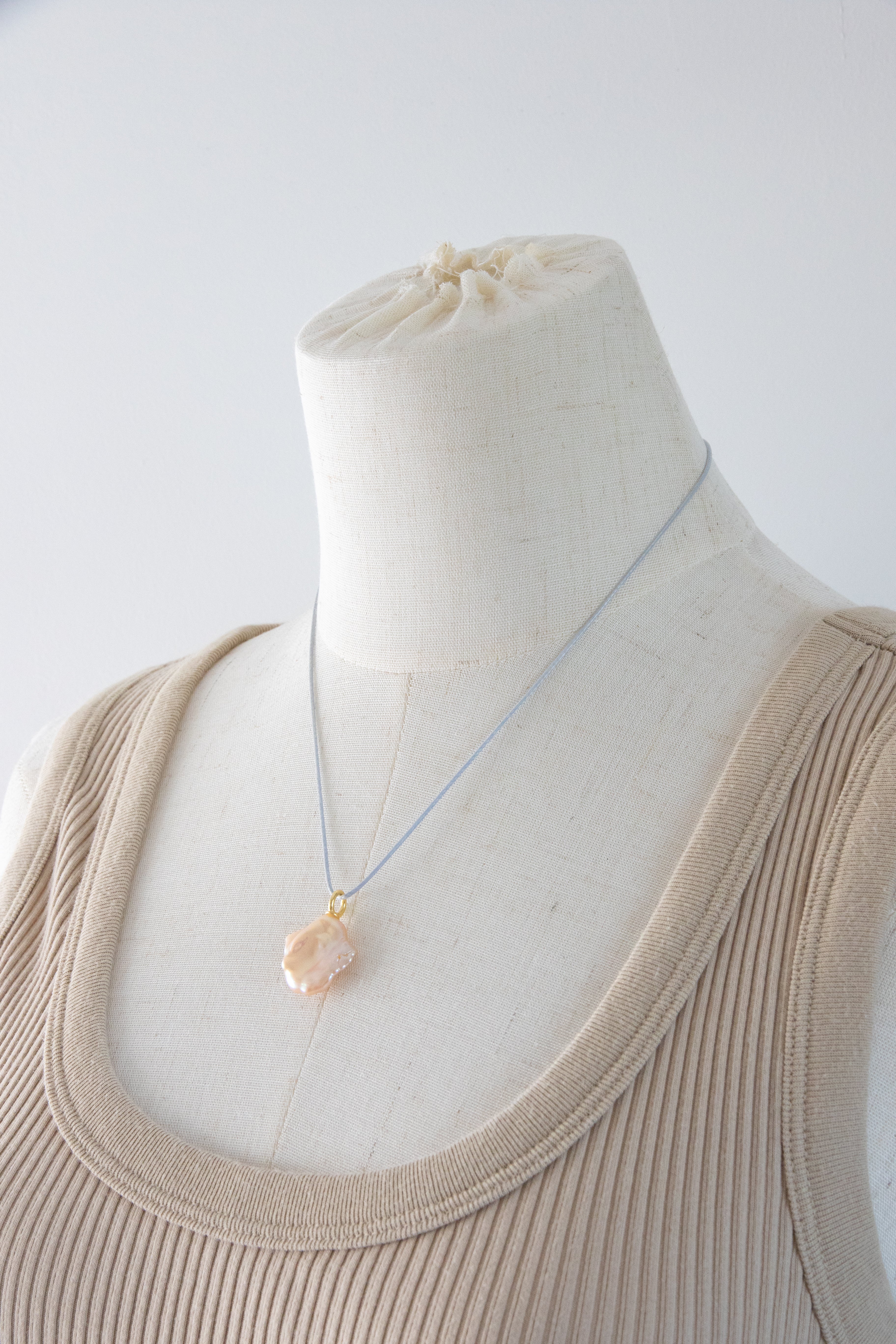 Watery sunset lake-natural orange pink colored thick seedless petal pearl pendant.