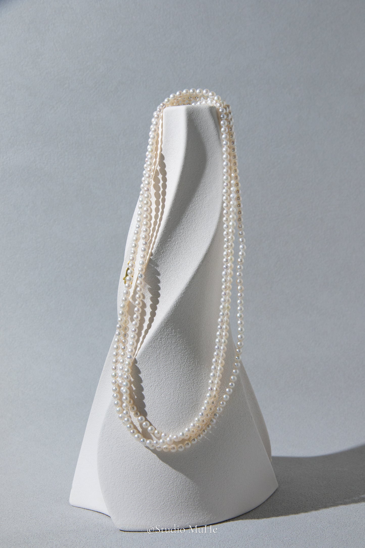 1.2 meters long necklace with small round white pearls.