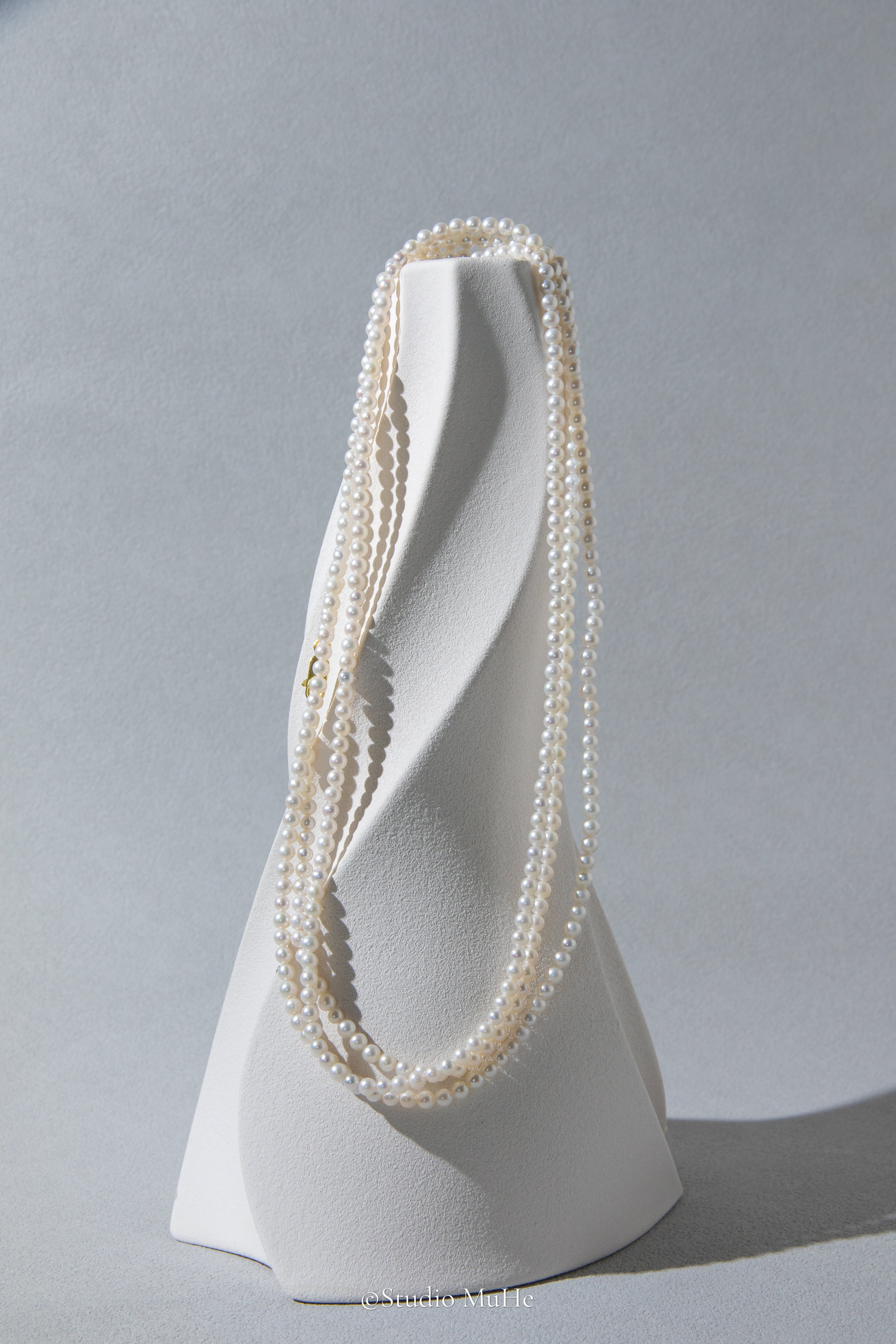 1.2 meters long necklace with small round white pearls.