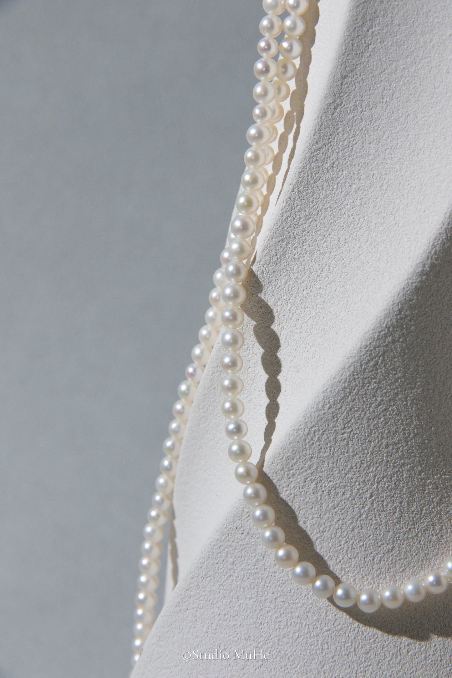 1.2 meters long necklace with small round white pearls.