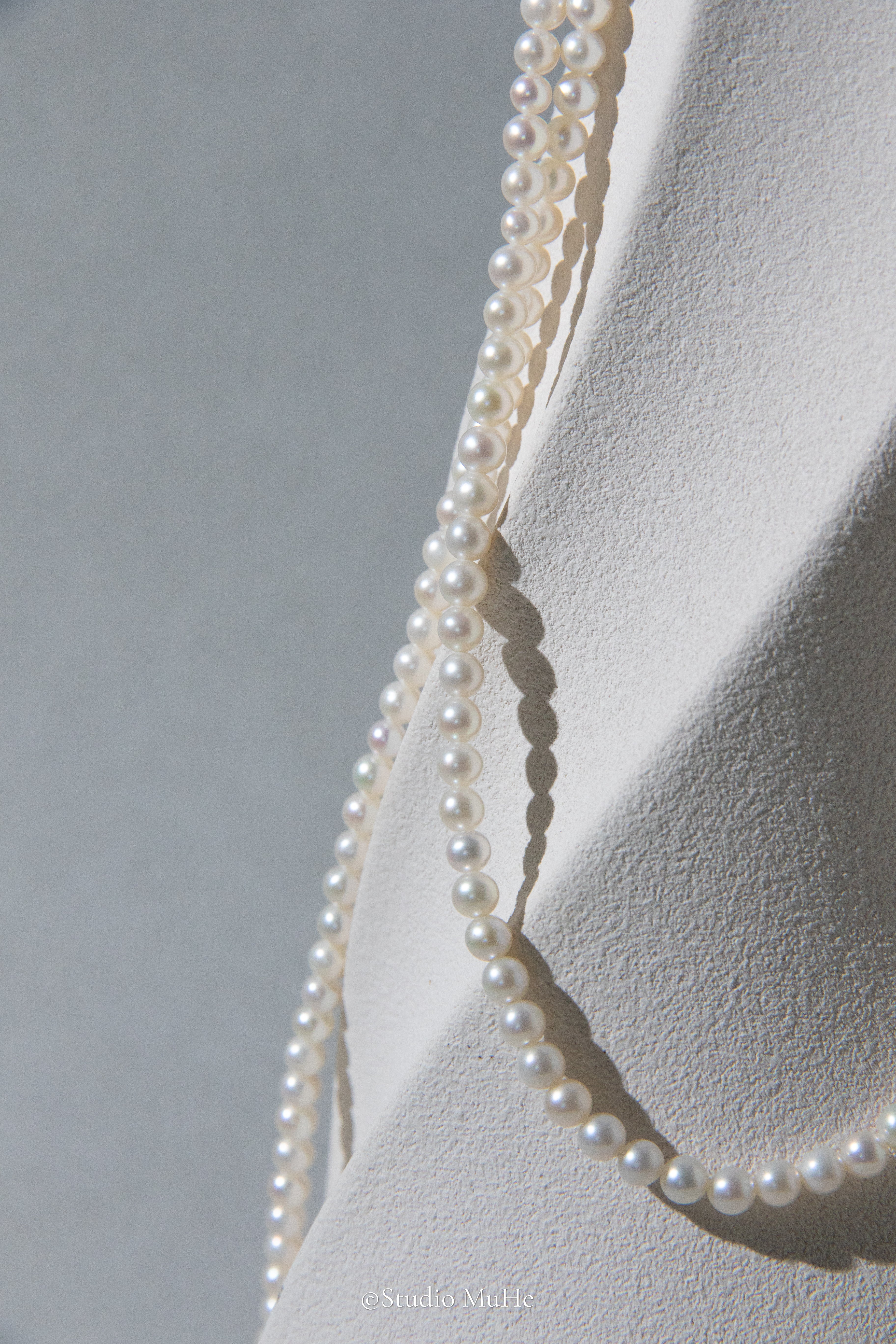 1.2 meters long necklace with small round white pearls.