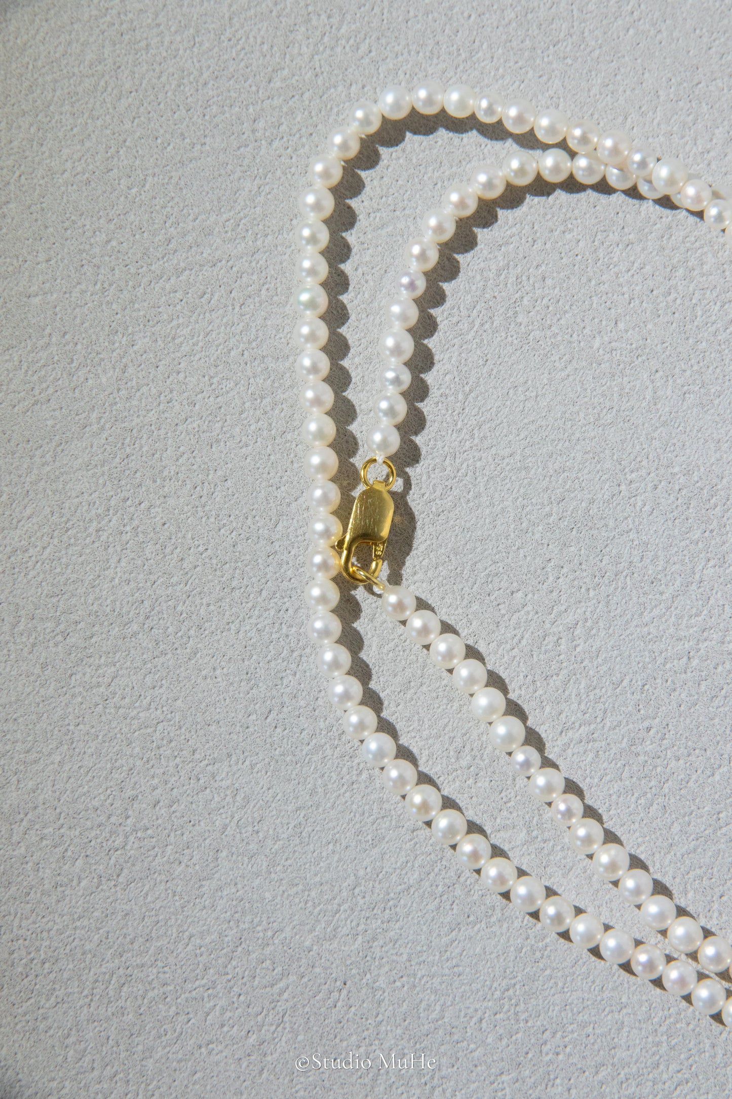 1.2 meters long necklace with small round white pearls.
