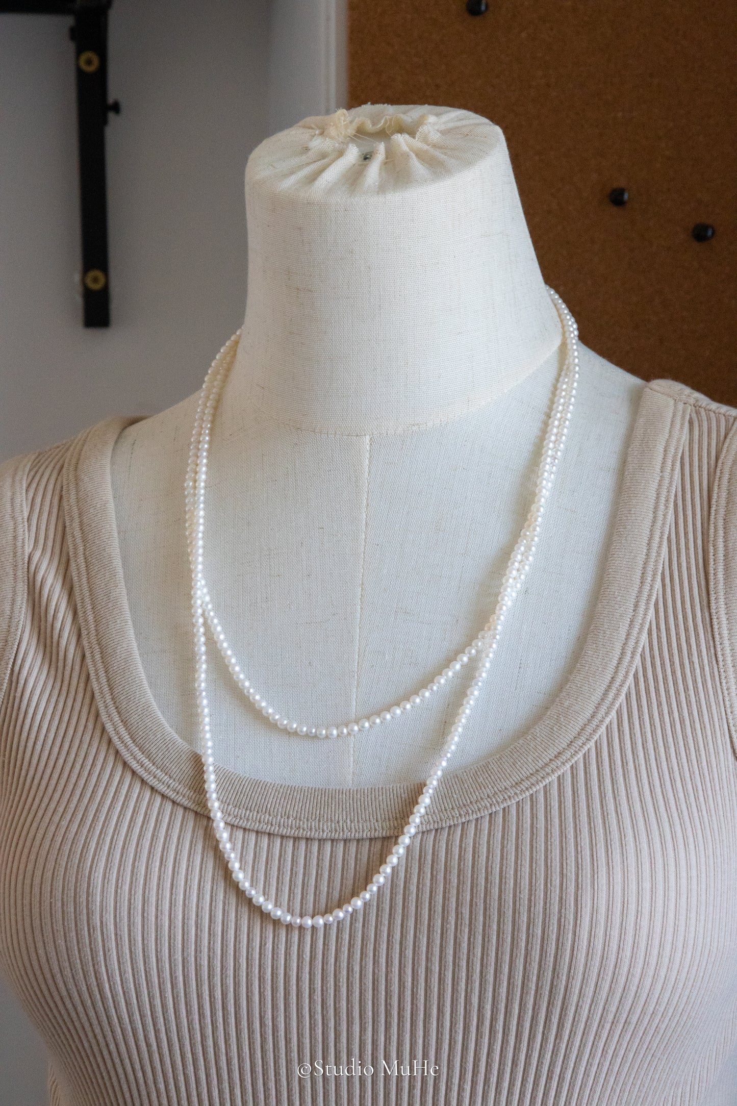 1.2 meters long necklace with small round white pearls.