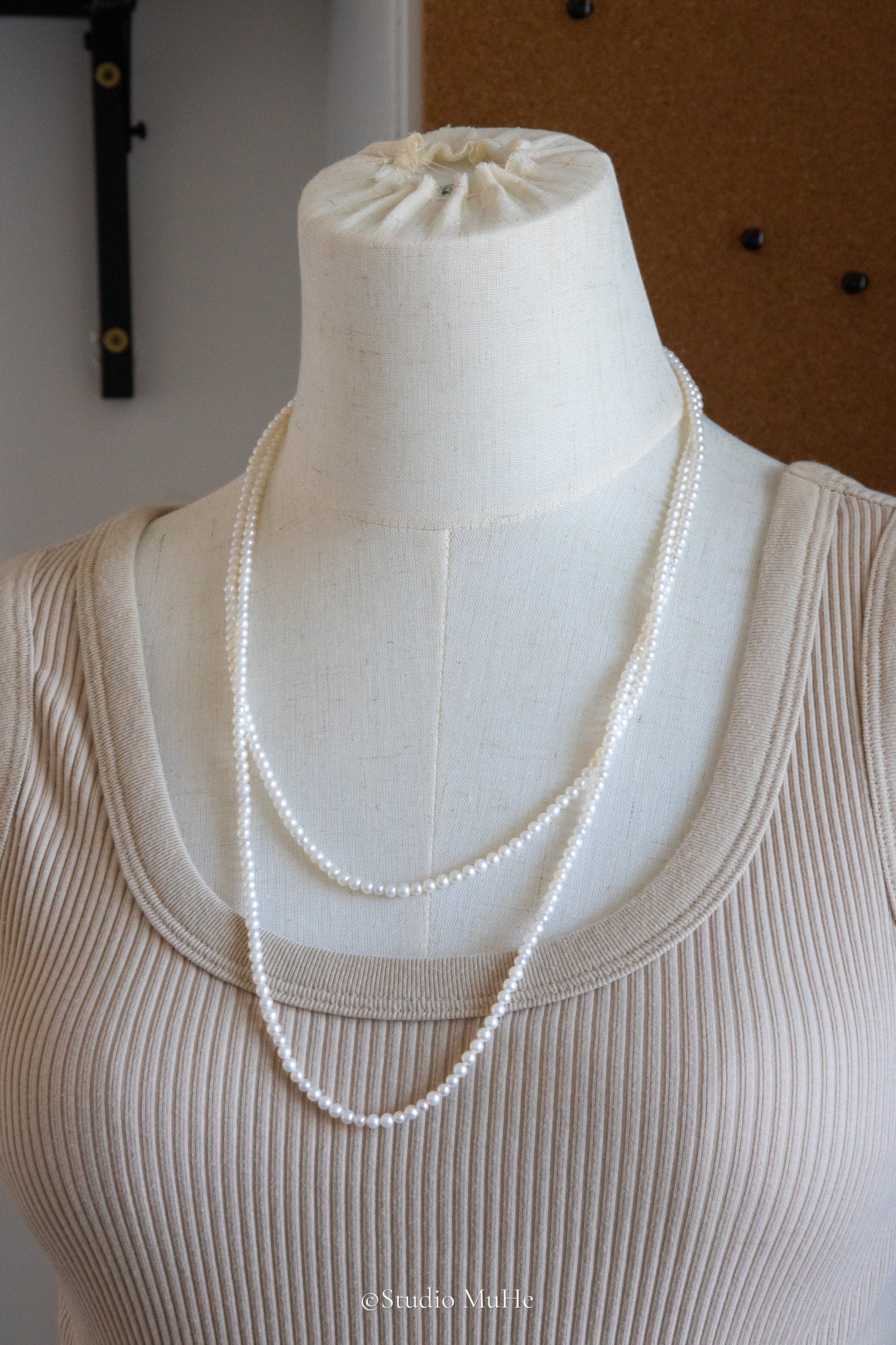 1.2 meters long necklace with small round white pearls.