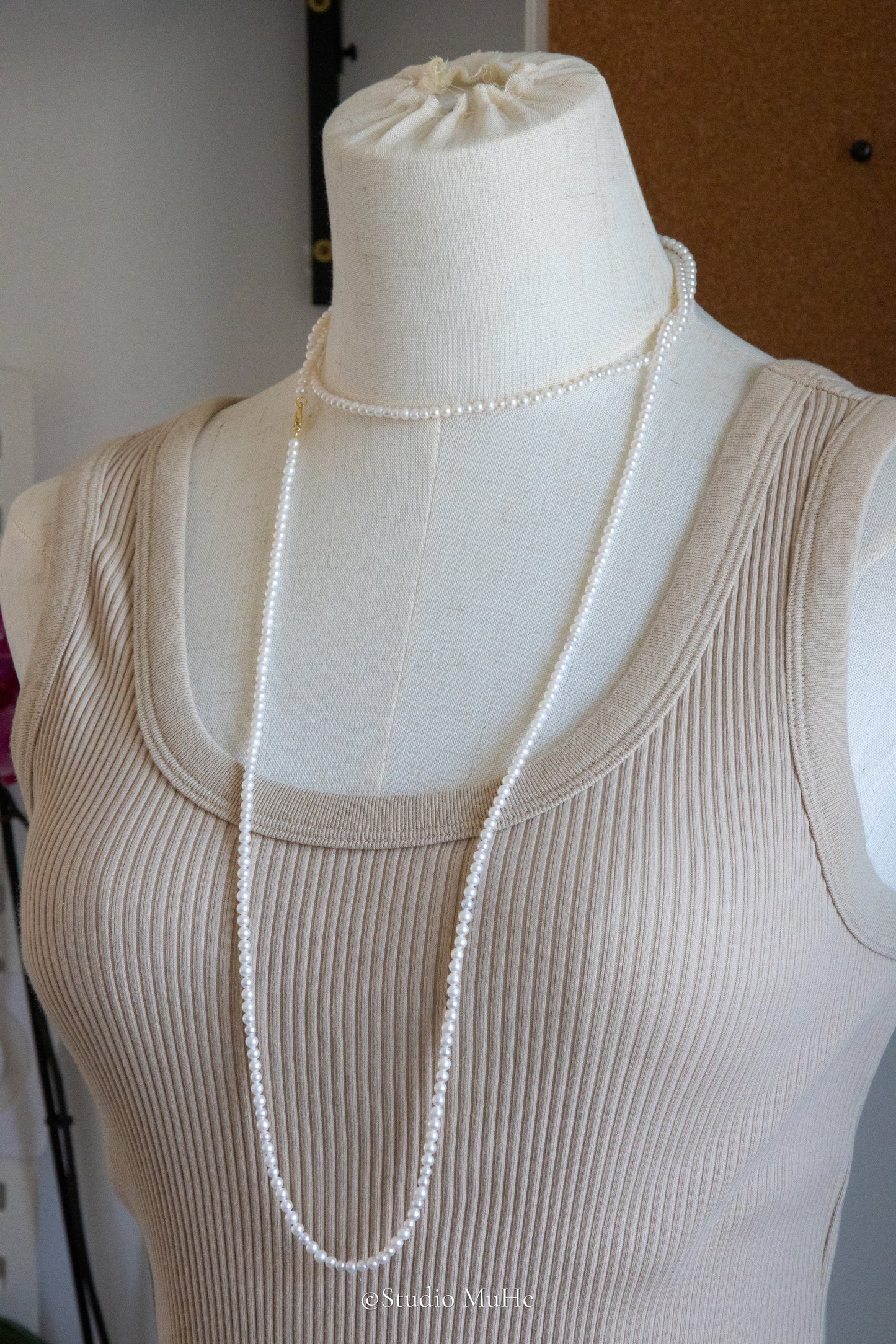 1.2 meters long necklace with small round white pearls.