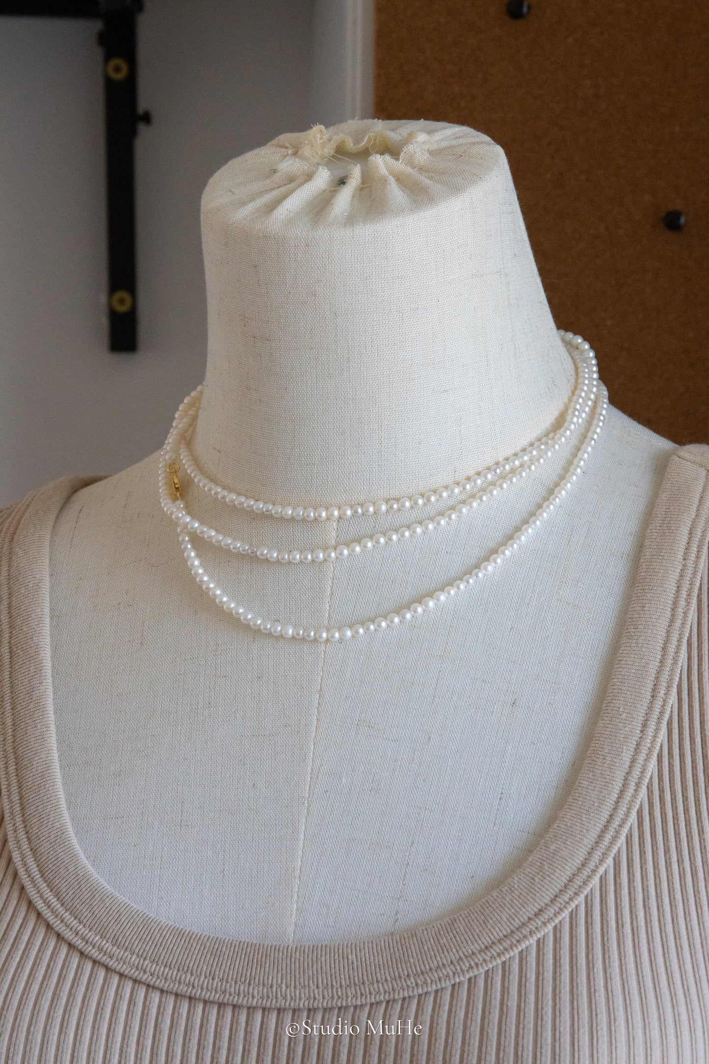 1.2 meters long necklace with small round white pearls.