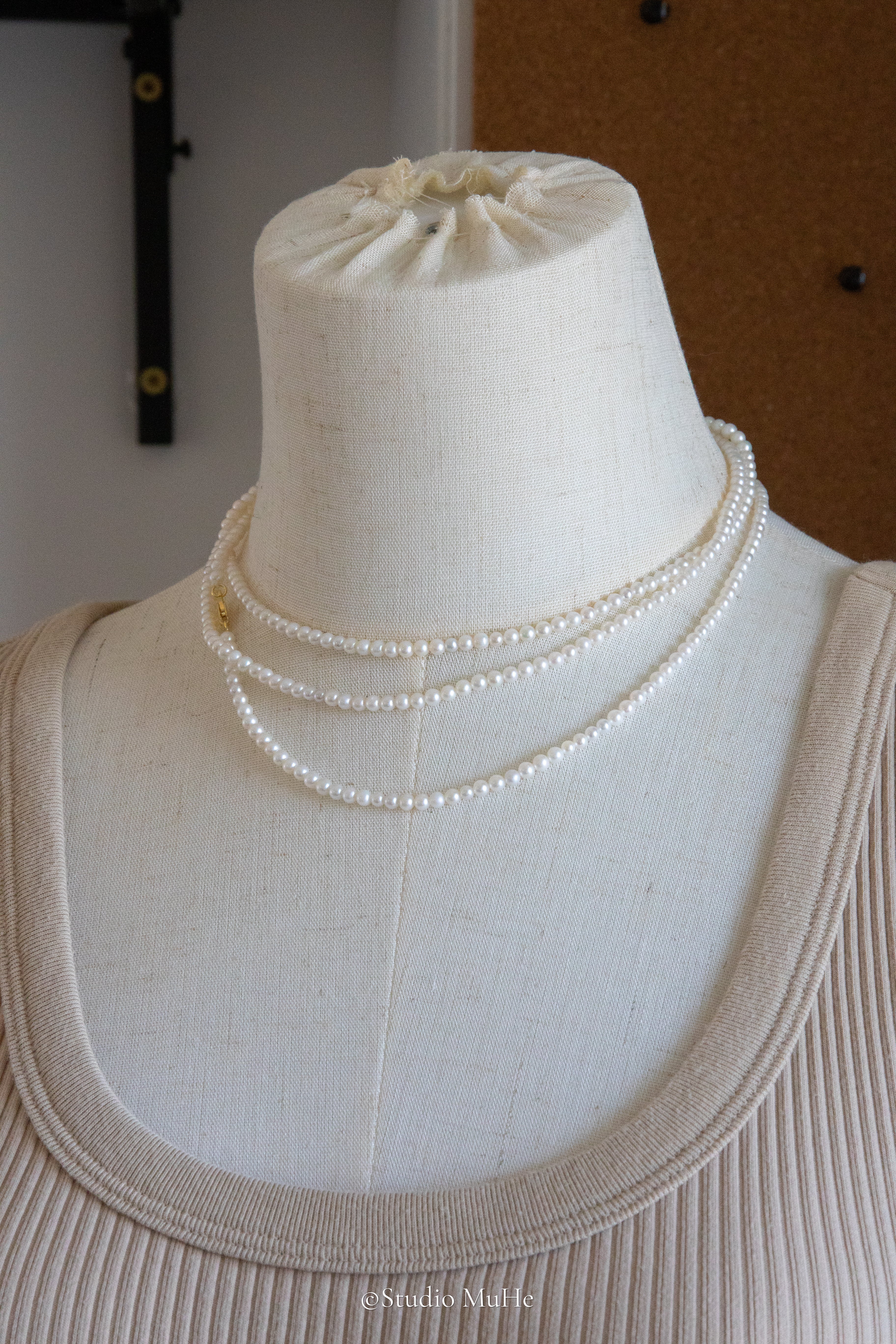 1.2 meters long necklace with small round white pearls.