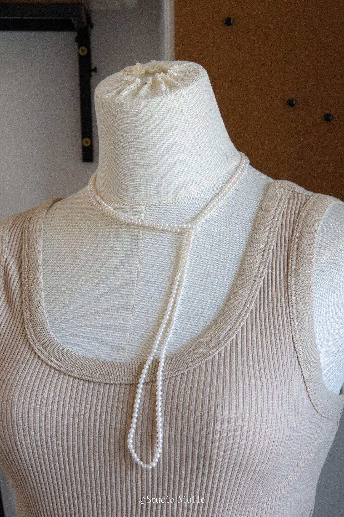 1.2 meters long necklace with small round white pearls.