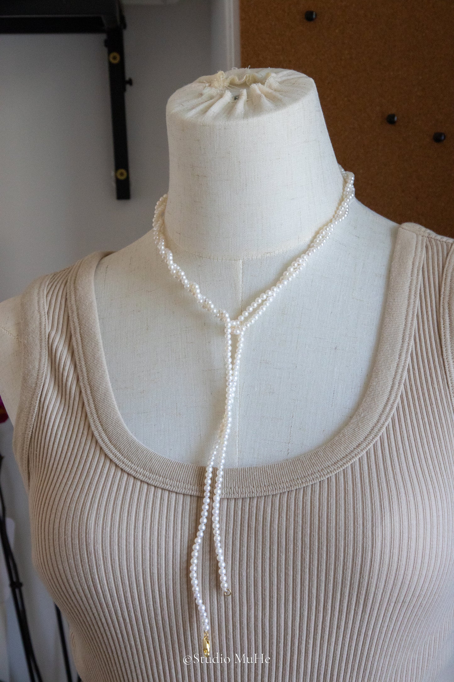 1.2 meters long necklace with small round white pearls.