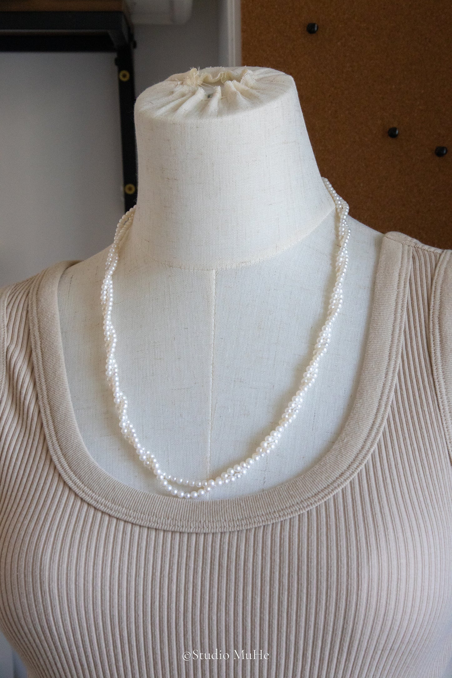 1.2 meters long necklace with small round white pearls.