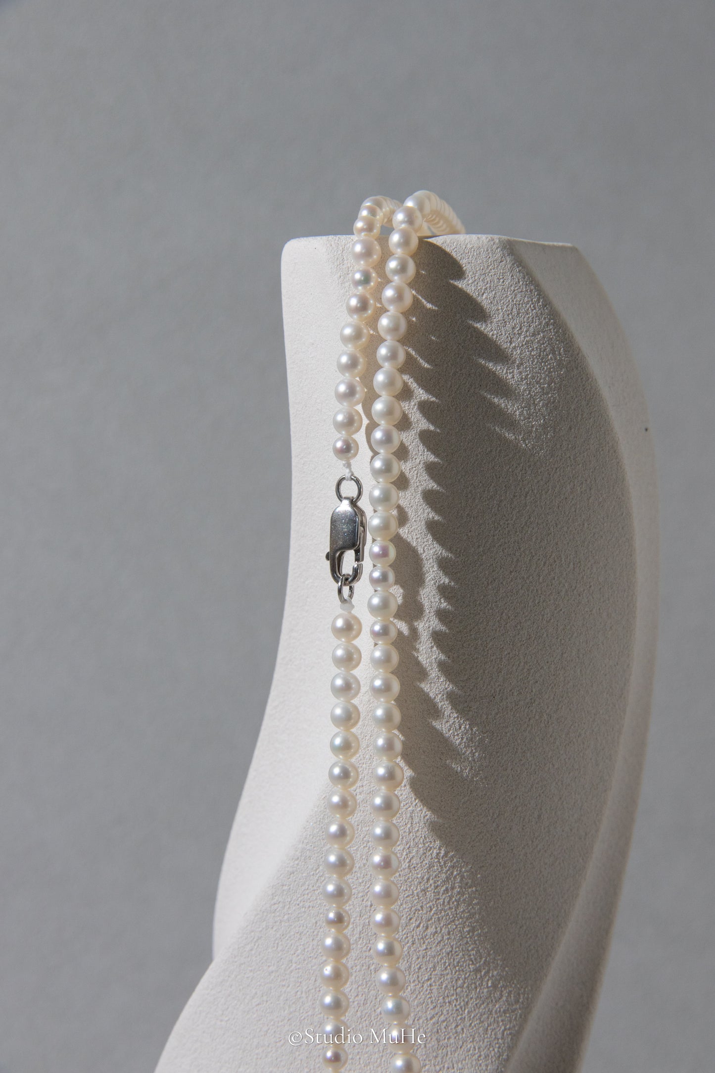 1.2 meters long necklace with small round white pearls.