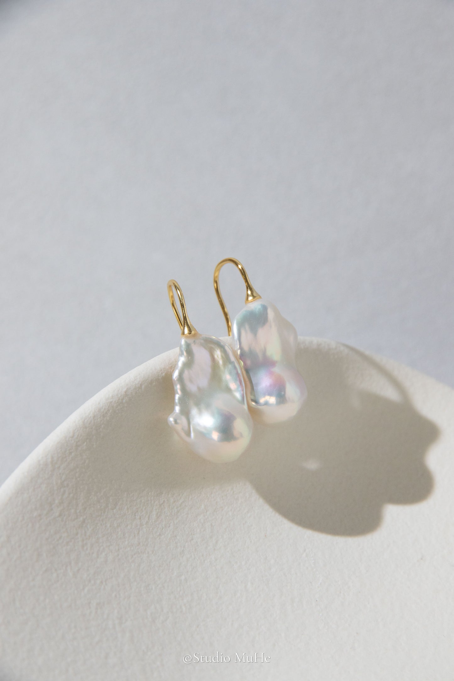 Medium sized flawless white baroque pearl earrings.