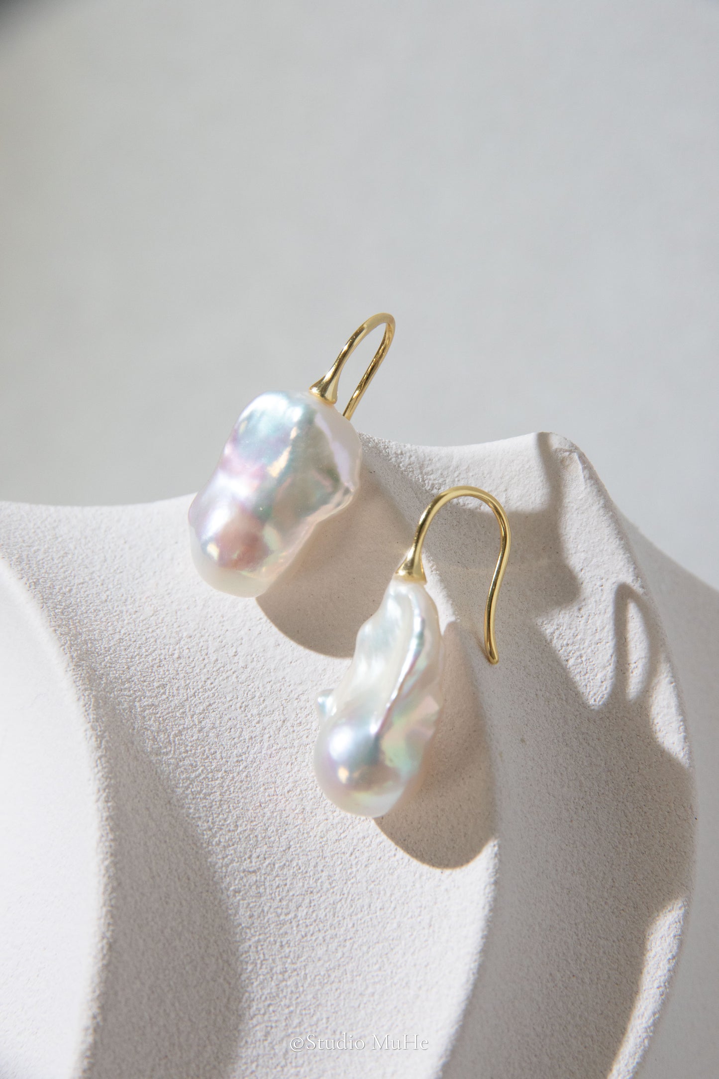 Medium sized flawless white baroque pearl earrings.