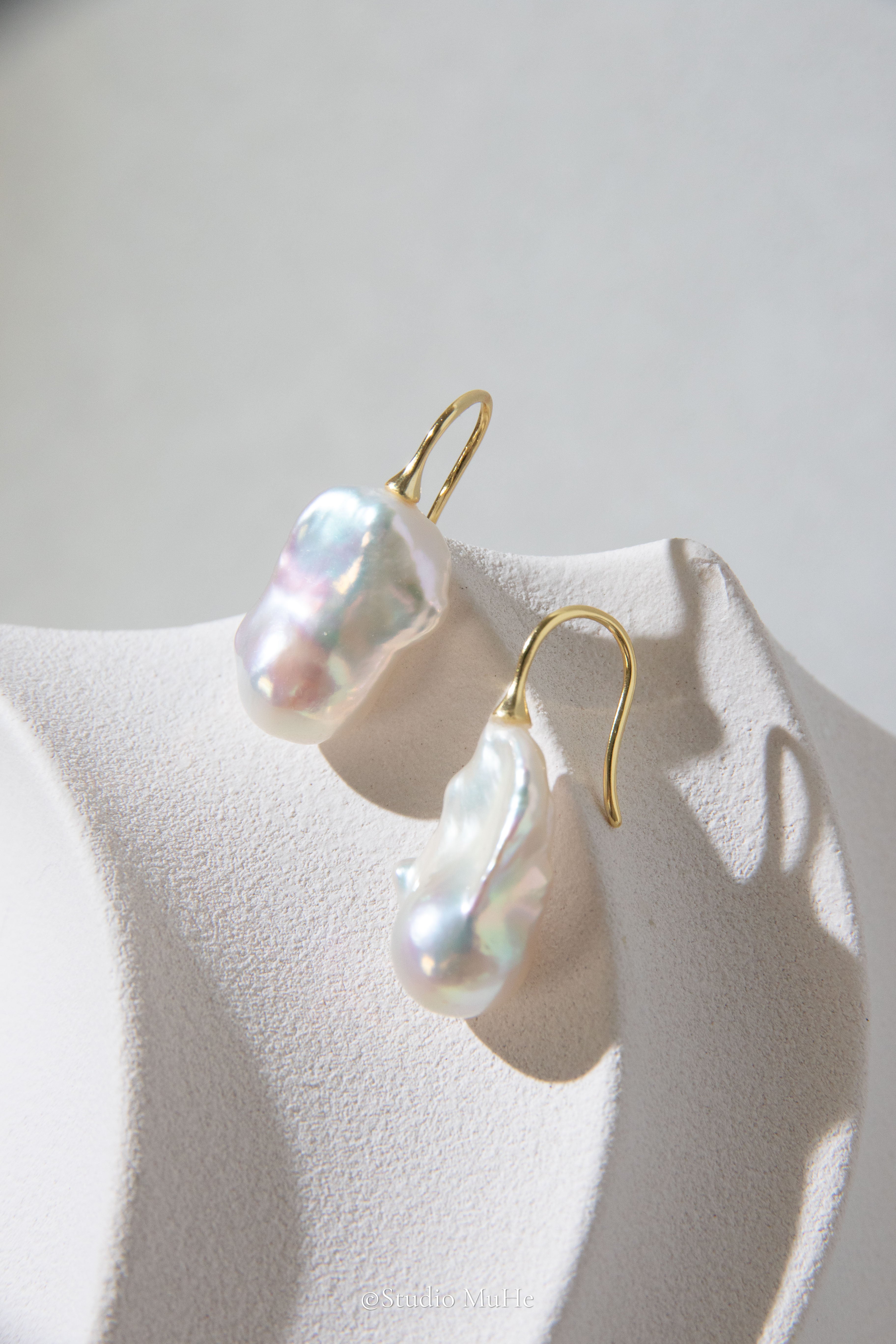 Medium sized flawless white baroque pearl earrings.