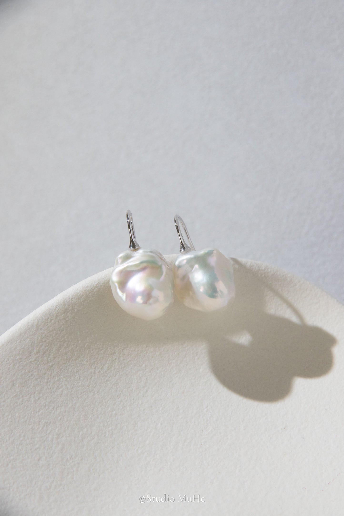 Medium sized flawless white baroque pearl earrings.