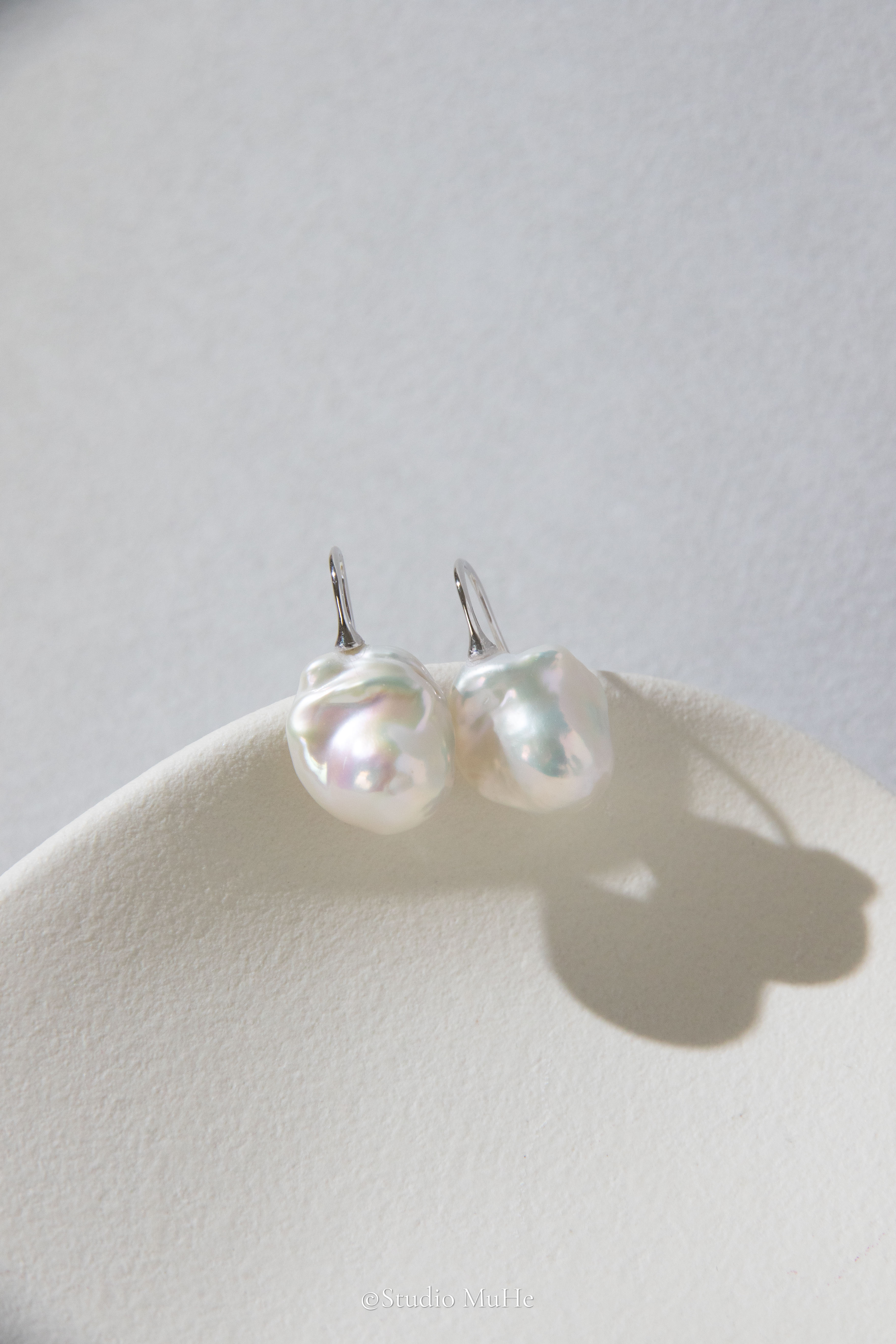 Medium sized flawless white baroque pearl earrings.