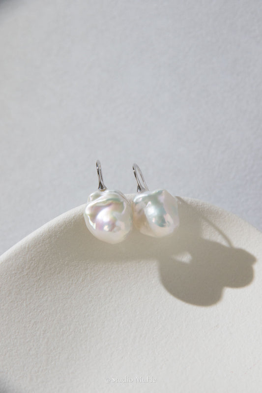 Medium sized flawless white baroque pearl earrings.