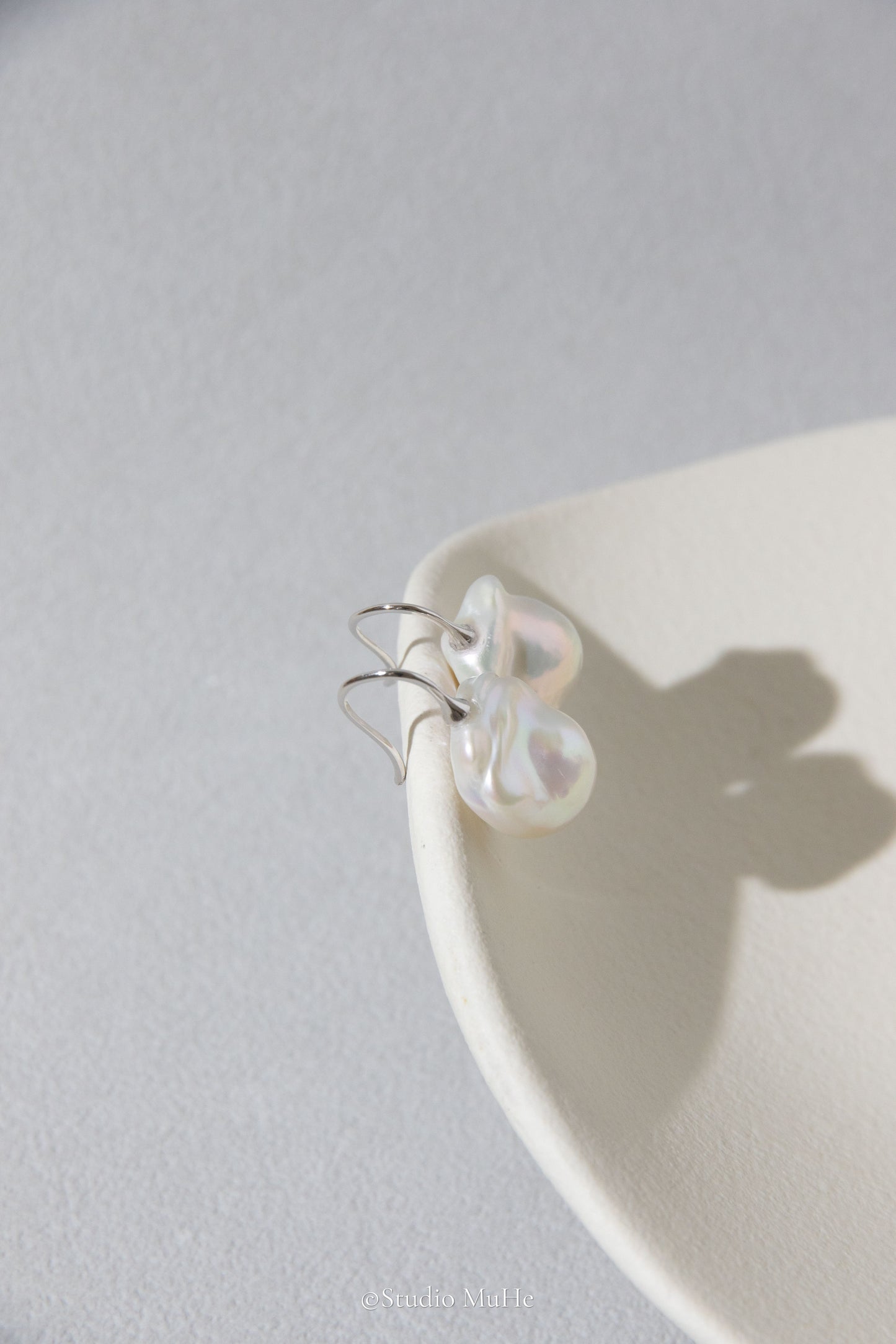 Medium sized flawless white baroque pearl earrings.