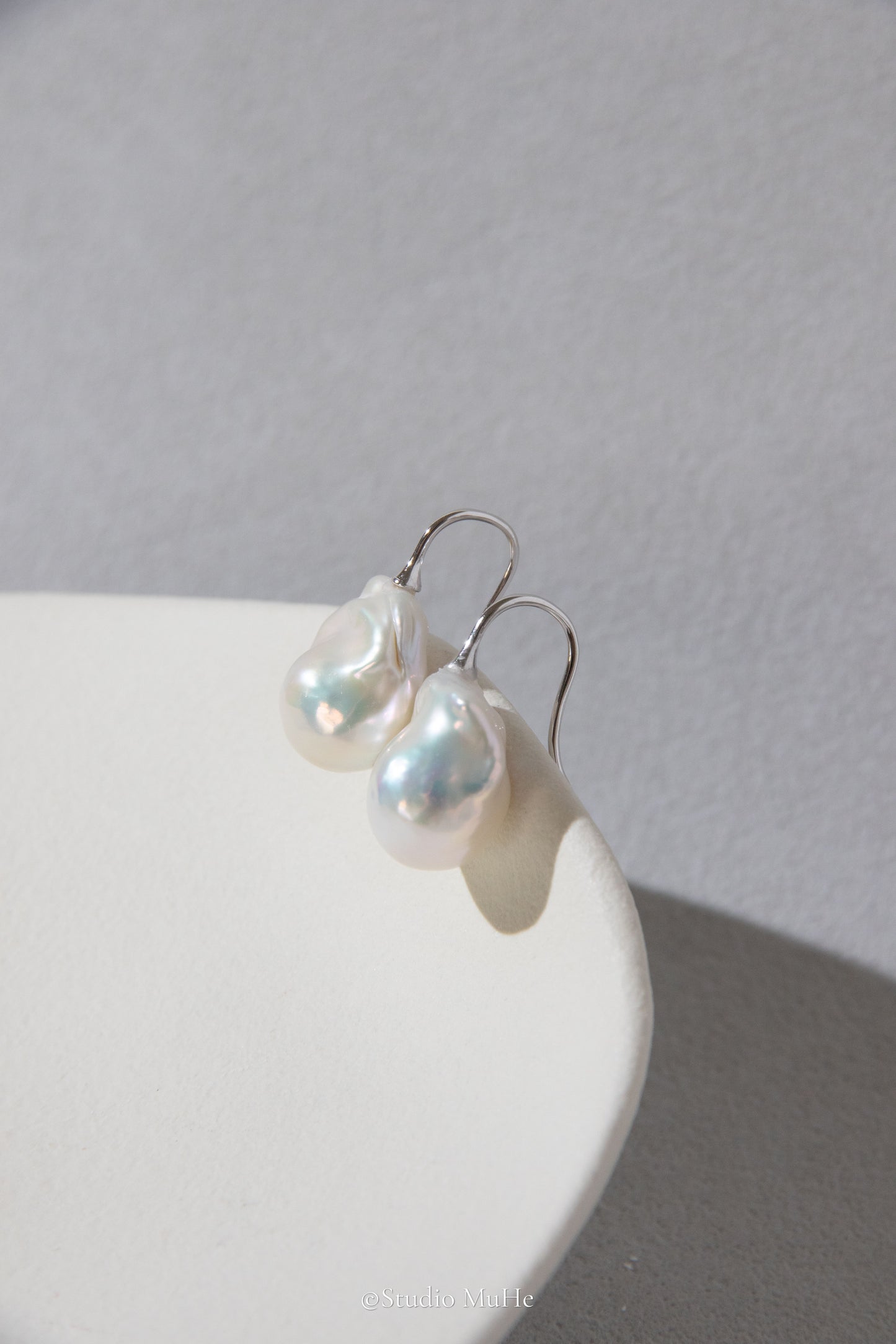 Medium sized flawless white baroque pearl earrings.