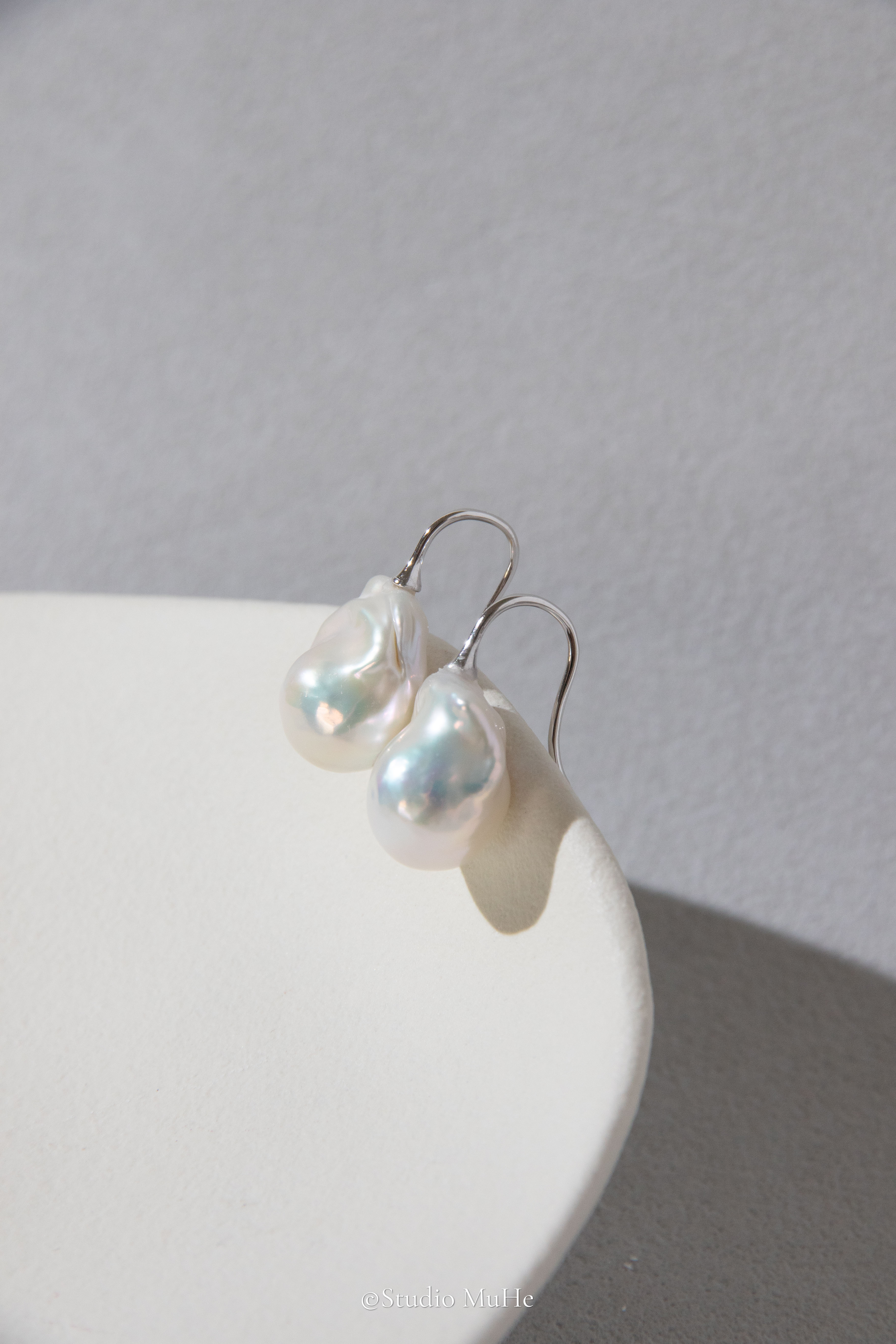 Medium sized flawless white baroque pearl earrings.