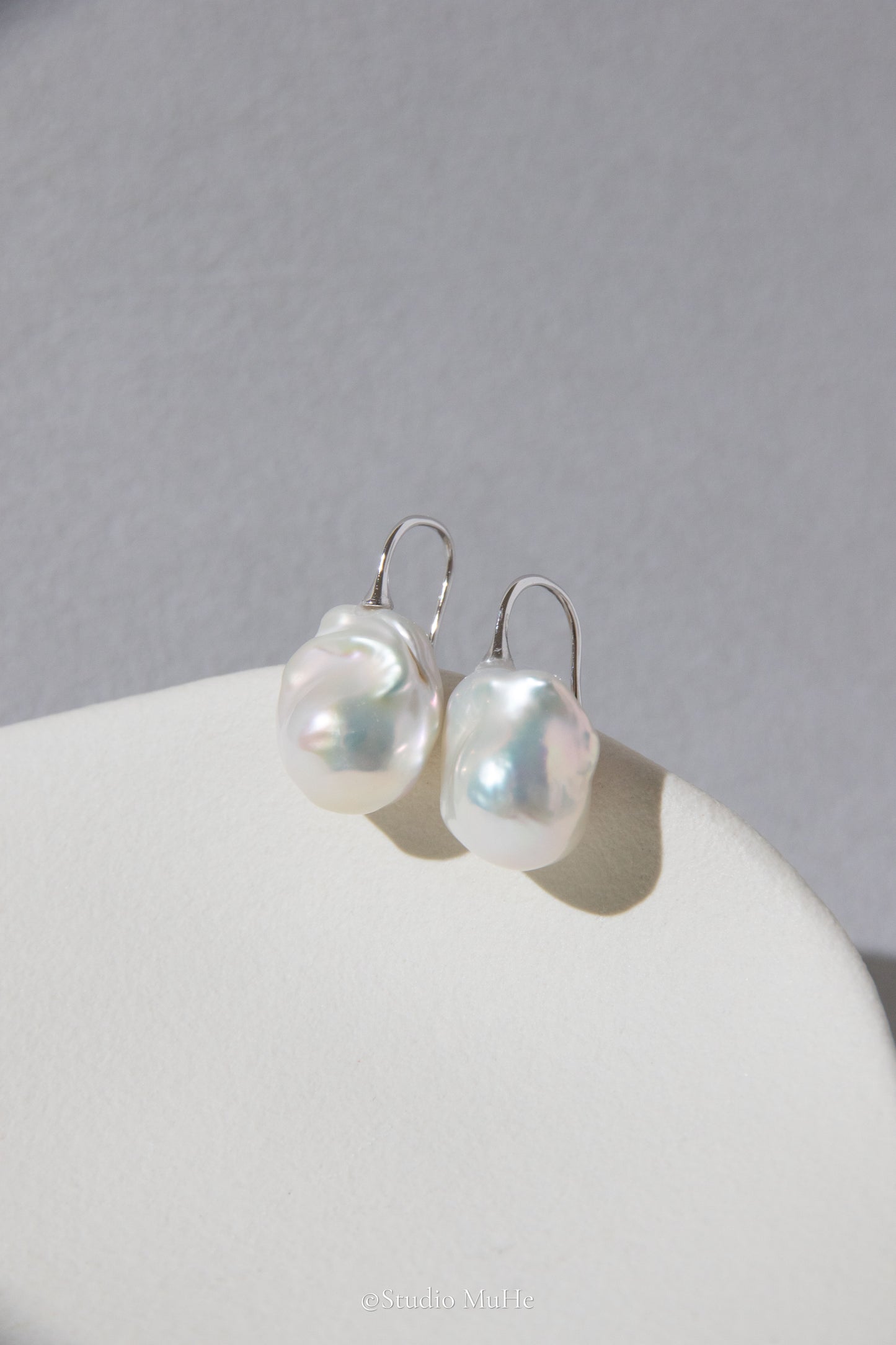 Medium sized flawless white baroque pearl earrings.