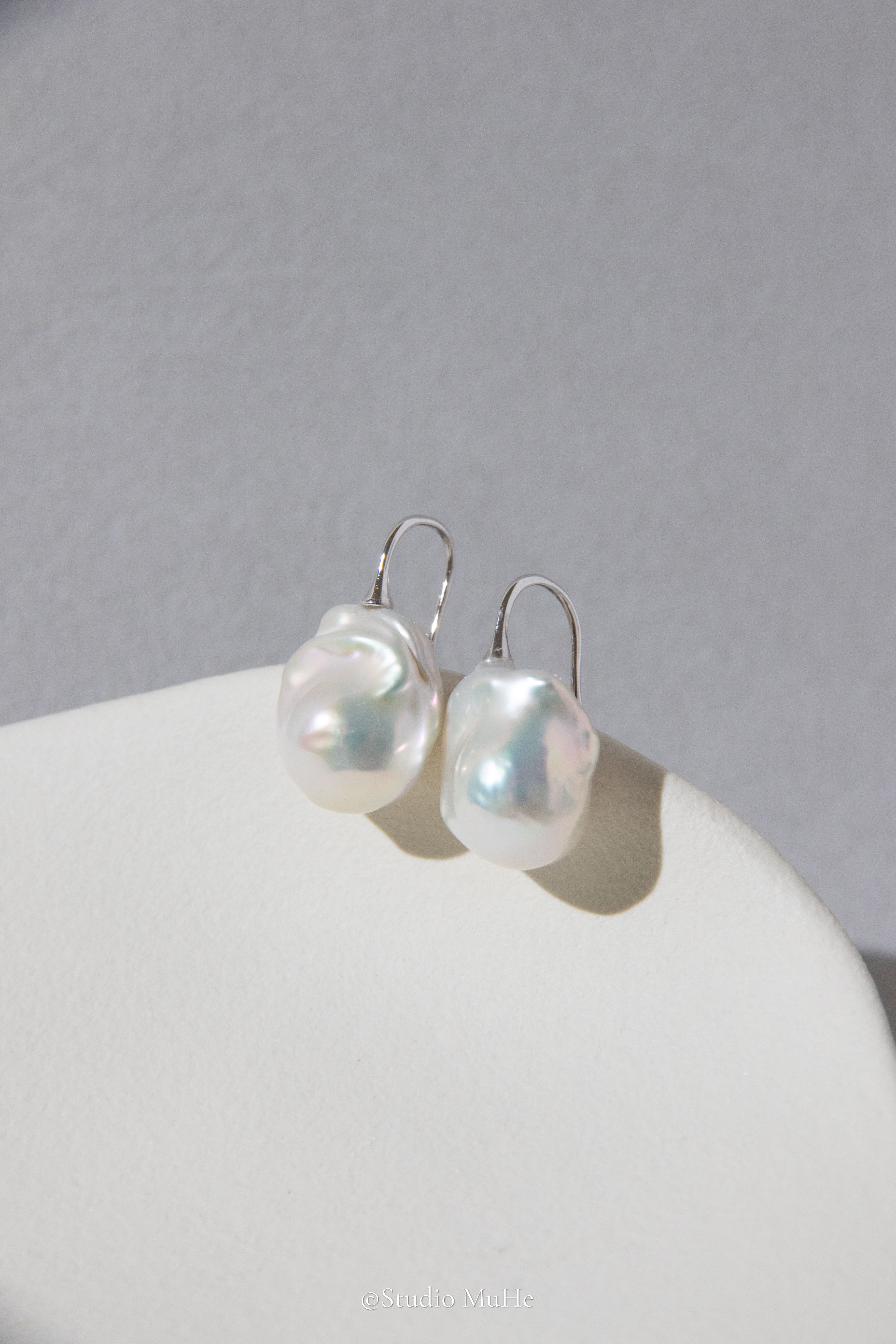 Medium sized flawless white baroque pearl earrings.