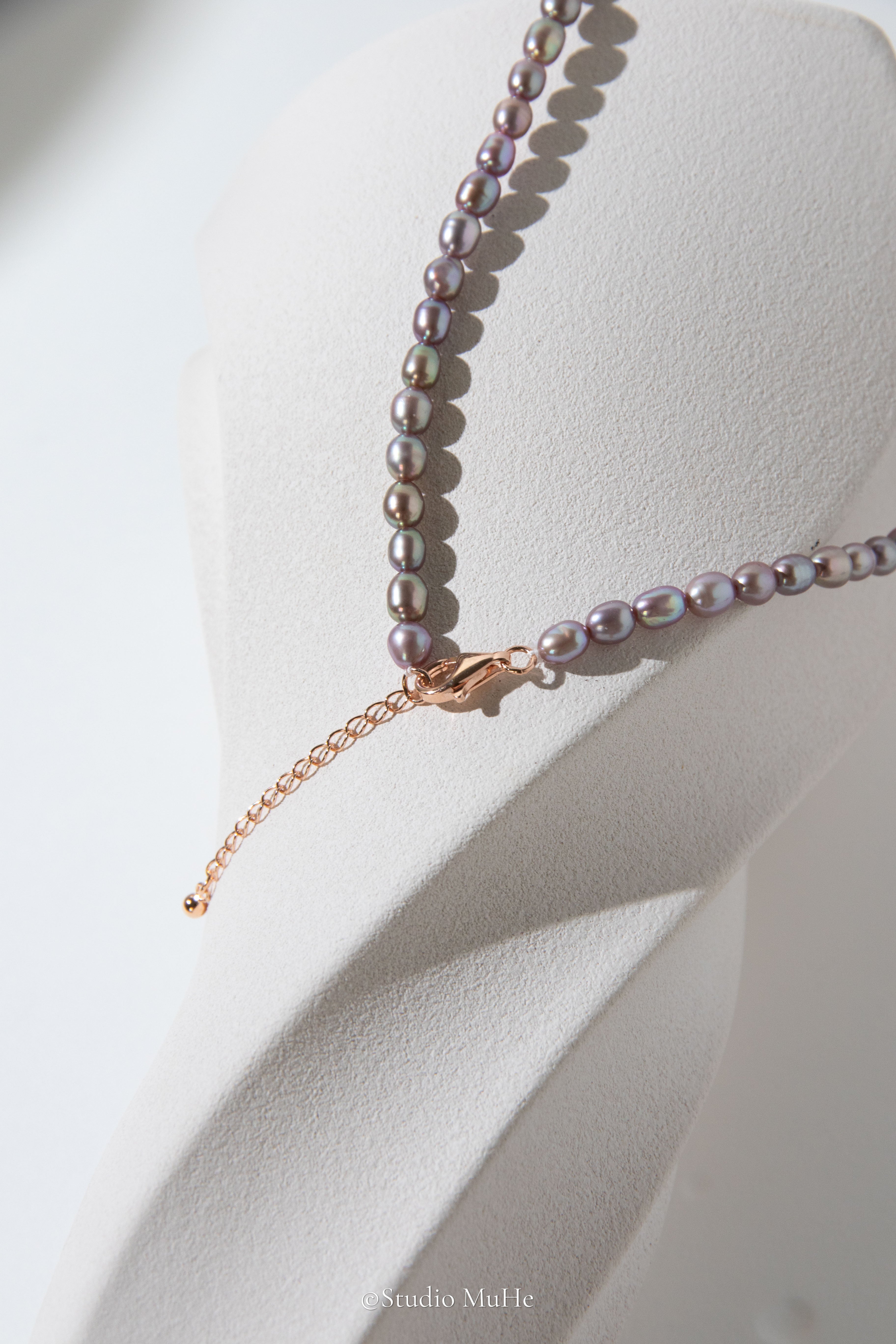 entry level metallic purple and green colored rice pearls necklace