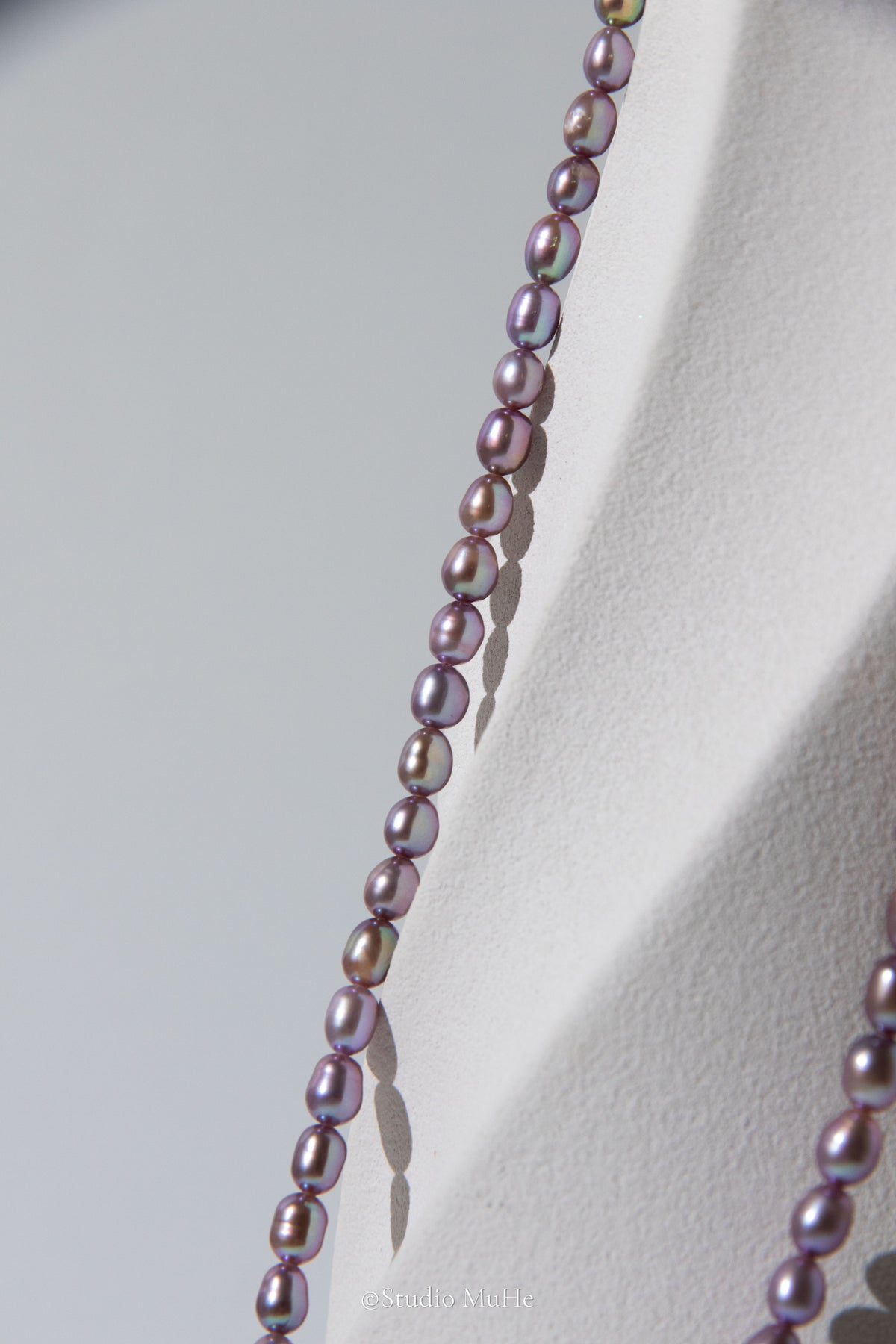 entry level metallic purple and green colored rice pearls necklace
