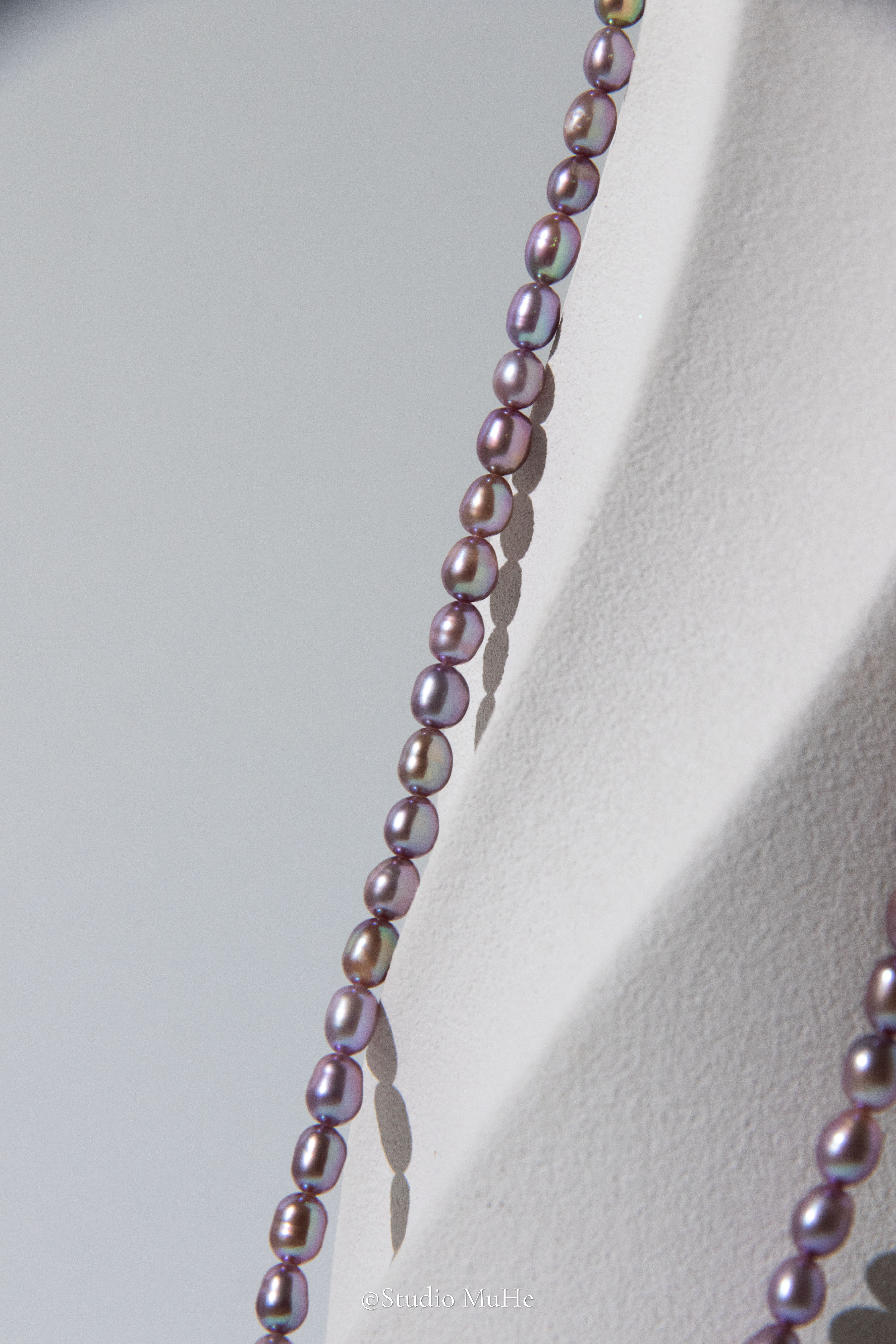 entry level metallic purple and green colored rice pearls necklace