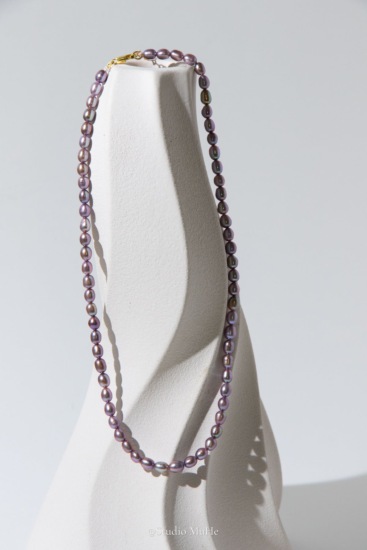 entry level metallic purple and green colored rice pearls necklace